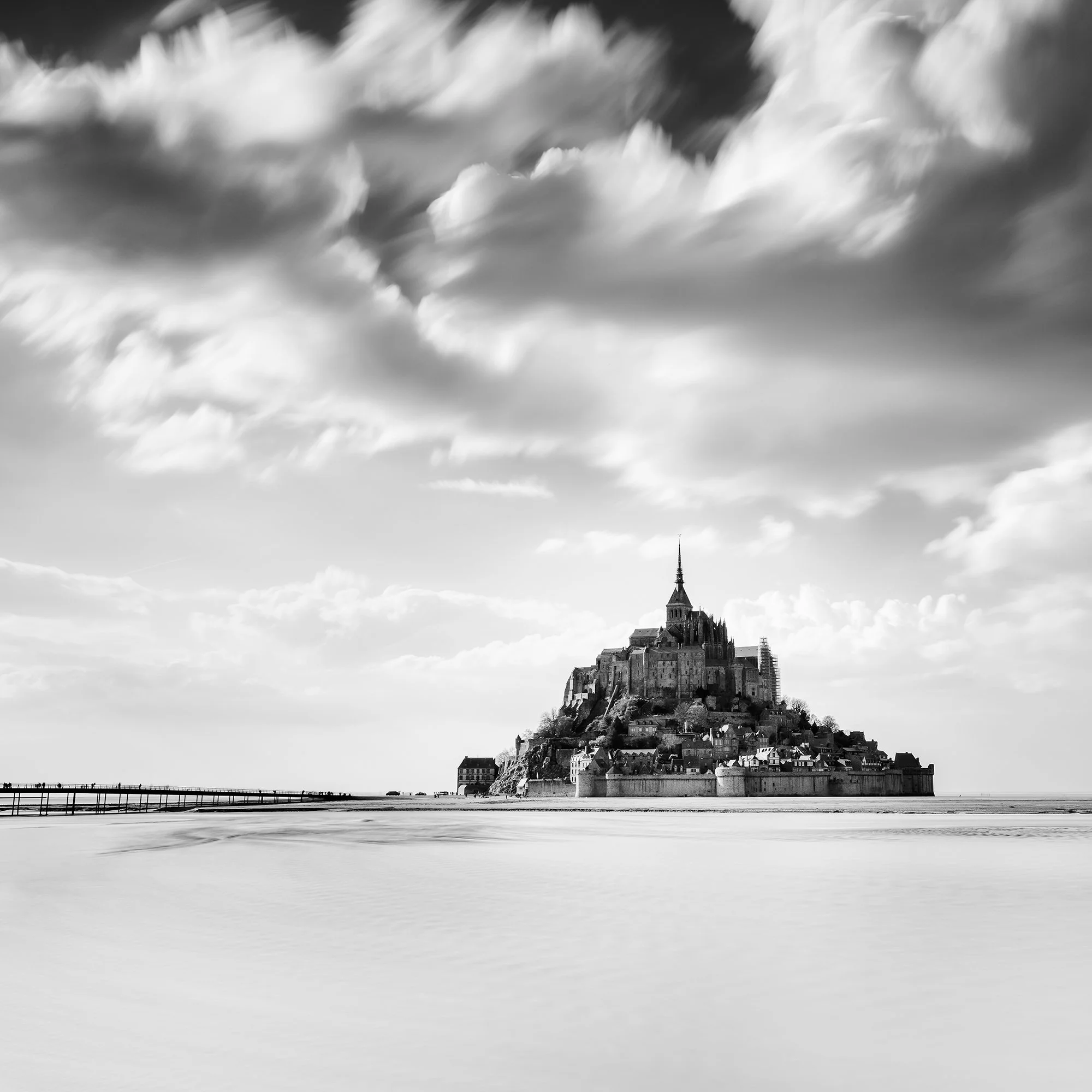 Detail of Mont-Saint-Michel and dramatic long-exposure clouds in Normandy, France, by Gerald Berghammer.