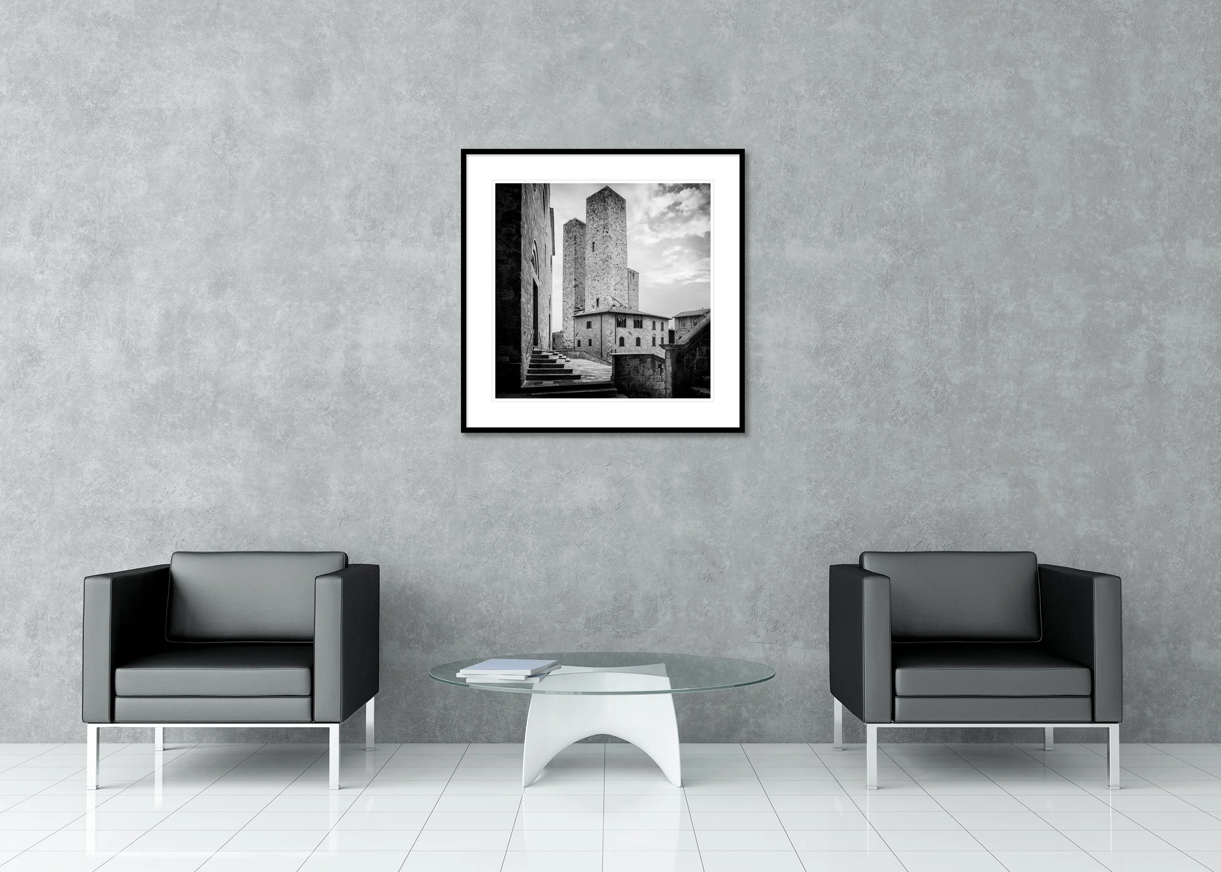 Monochrome archival pigment print of medieval towers above historic buildings in San Gimignano, Italy, presented in a classic frame with a mount.