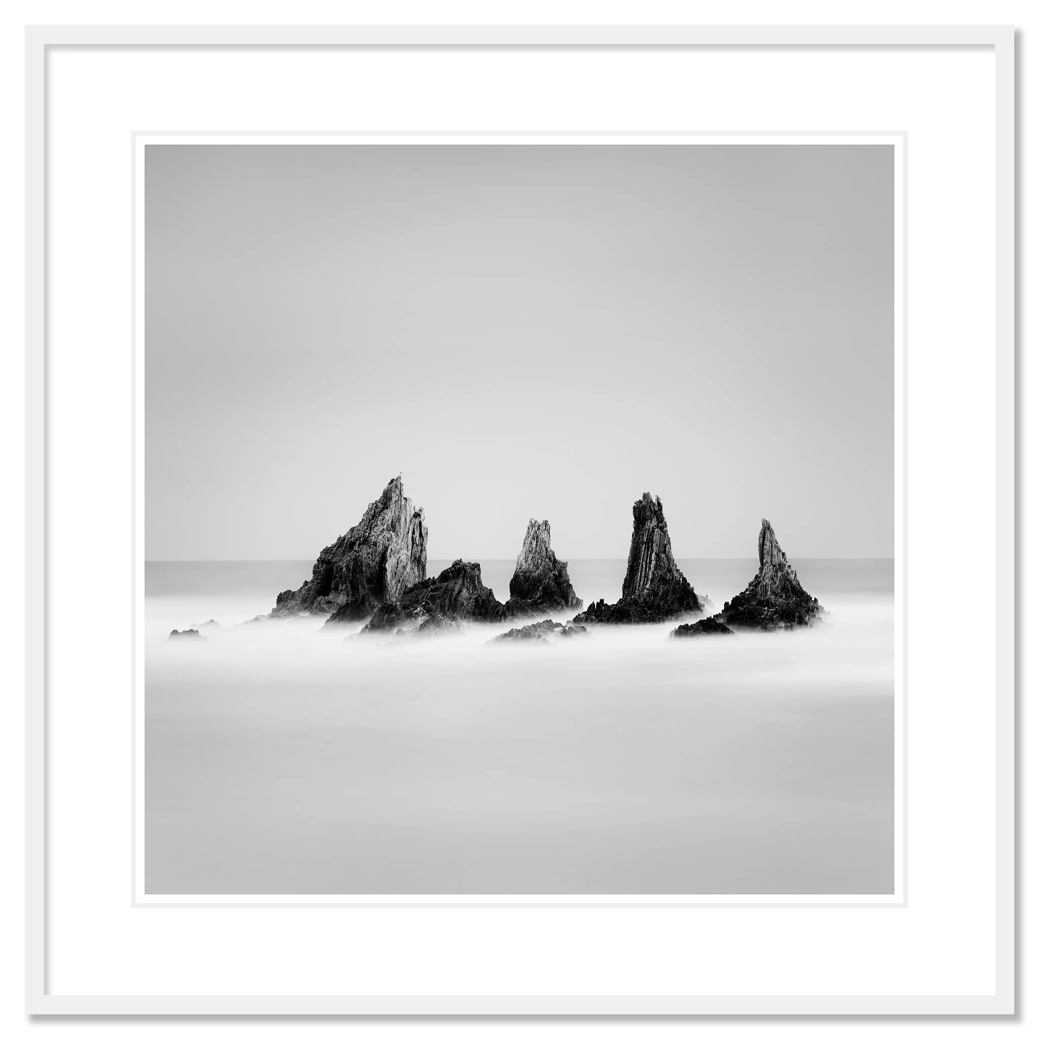 Rocky Peaks Study 1 by Gerald Berghammer, black-and-white seascape presented in a white aluminium frame with a white mount.