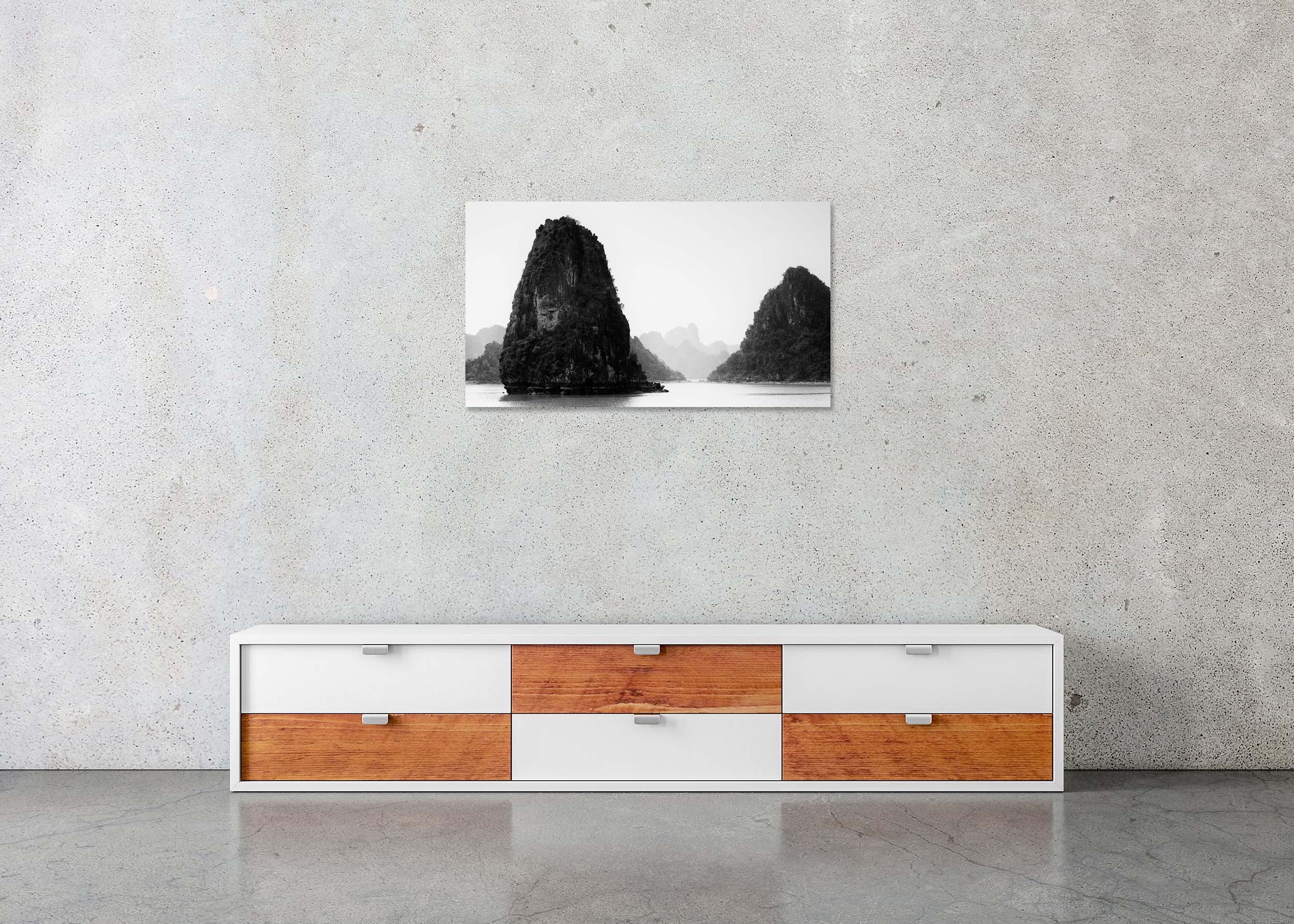 Black-and-white photo of misty limestone karsts rising from calm water in Ha Long Bay, creating a tranquil and minimalist seascape. ChromaLuxe Metal Print – Frameless