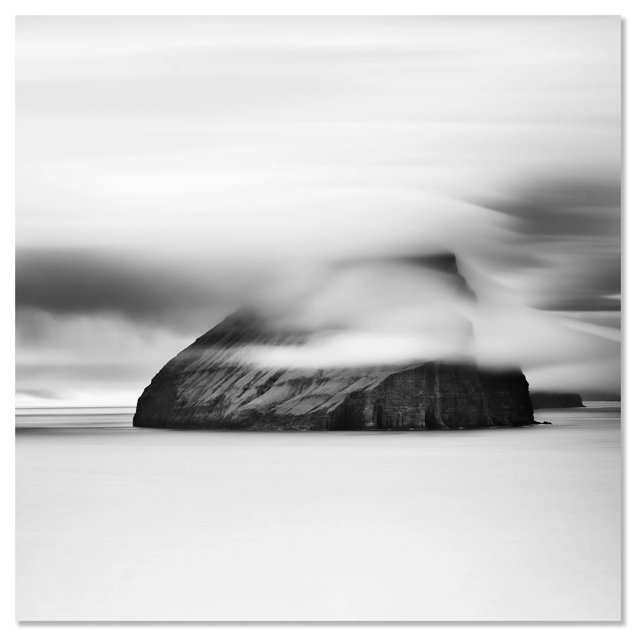 Minimalist monochrome seascape with a large sea stack, low cloud and smooth water – dibond frameless