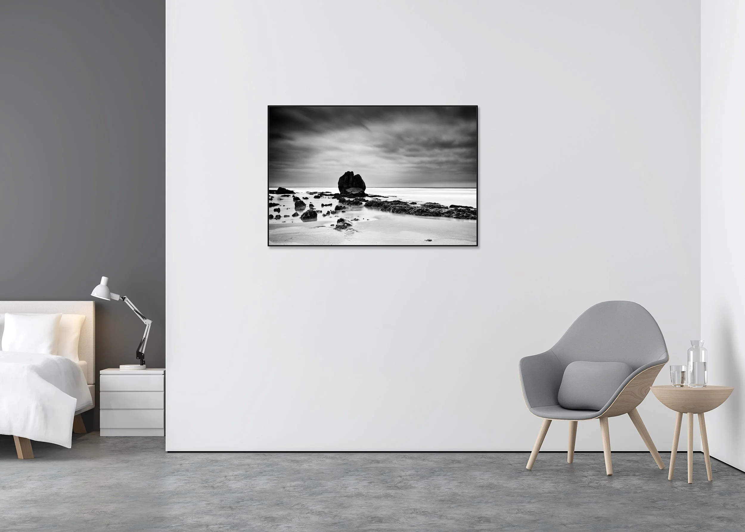 Dramatic black-and-white seascape with textured coastal rocks beneath a stormy sky, photo print mounted on Dibond in an aluminium ArtBox.