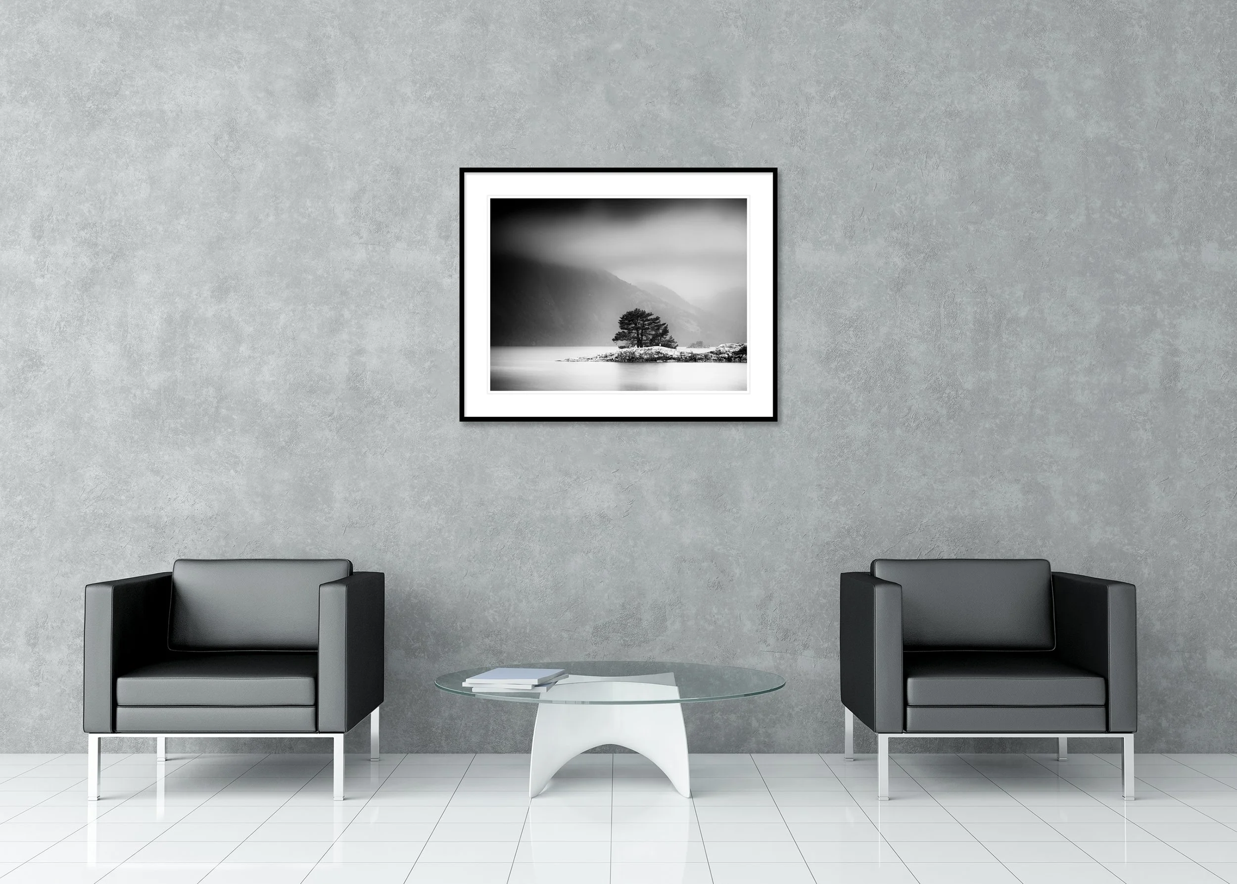 Atmospheric black and white lake scene with pine tree on a small island below foggy mountains, archival pigment print in classic frame with mount.