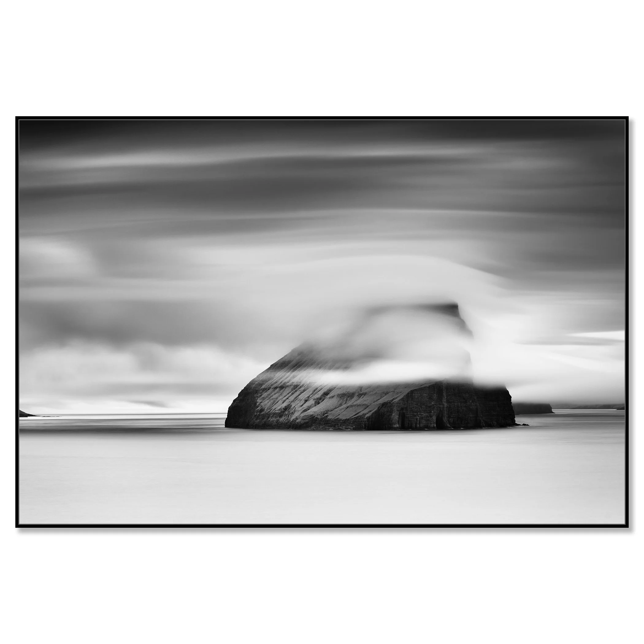Moody monochrome seascape of a rocky island in the Faroe Islands wrapped in mist and cloud – framed ArtBox black