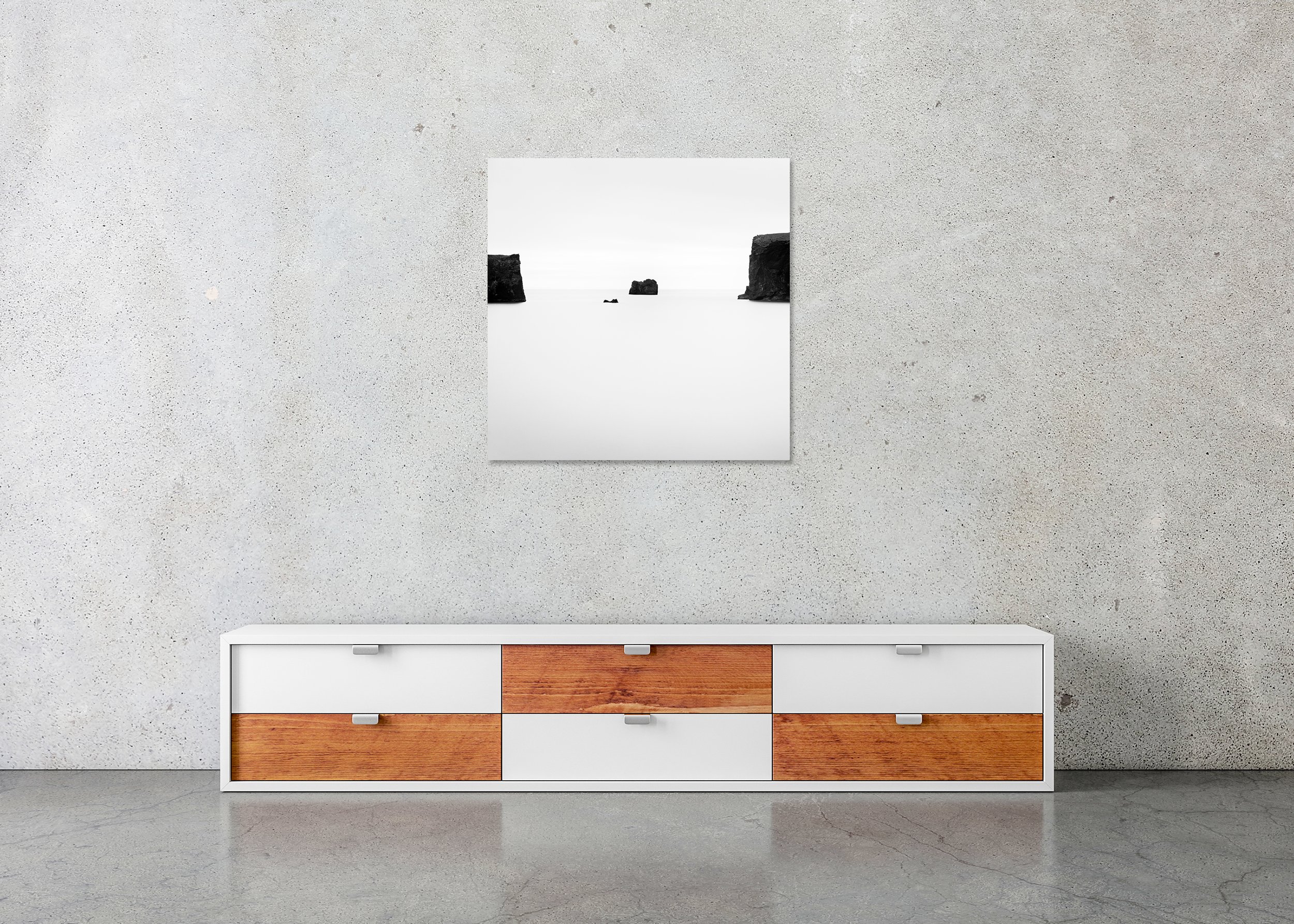 Black Rocks Study 2 – Iceland, frameless black-and-white photograph on aluminium Dibond displayed in a minimalist interior. Photo by Gerald Berghammer.