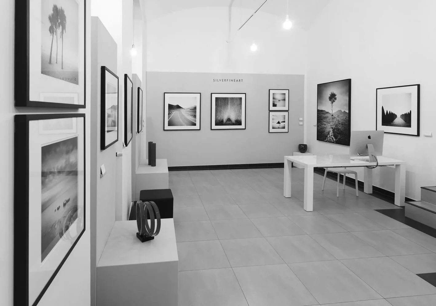 Wide interior view of SILVERFINEART Gallery during ART AFFAIR II 2019 in Vienna, displaying minimalist black-and-white photographs by Gerald Berghammer.