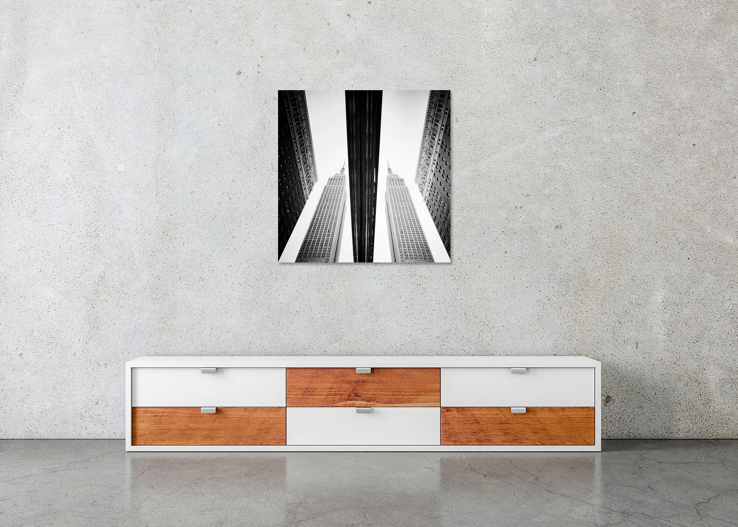 Black-and-white photograph of the Empire State Building reflected symmetrically in a shop window in New York City, presented as a frameless ChromaLuxe metal print.