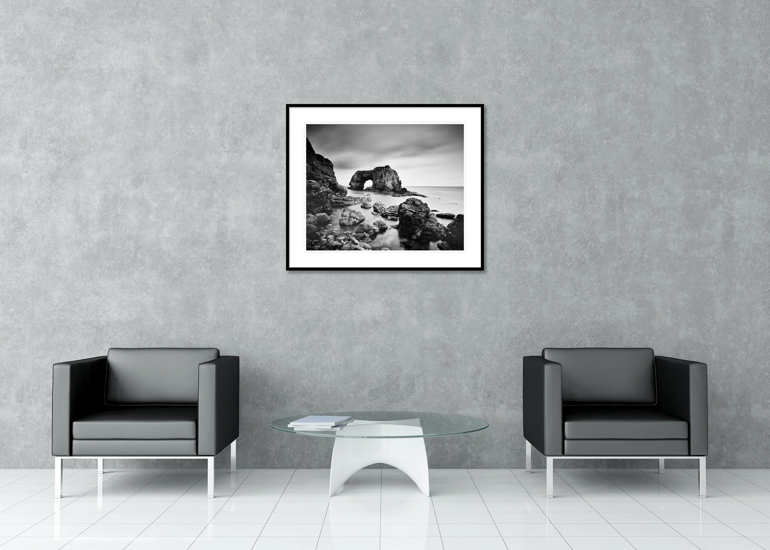 Monochrome archival pigment print of Great Pollet Sea Arch with dramatic rock formations and still ocean water in a classic frame with mount.
