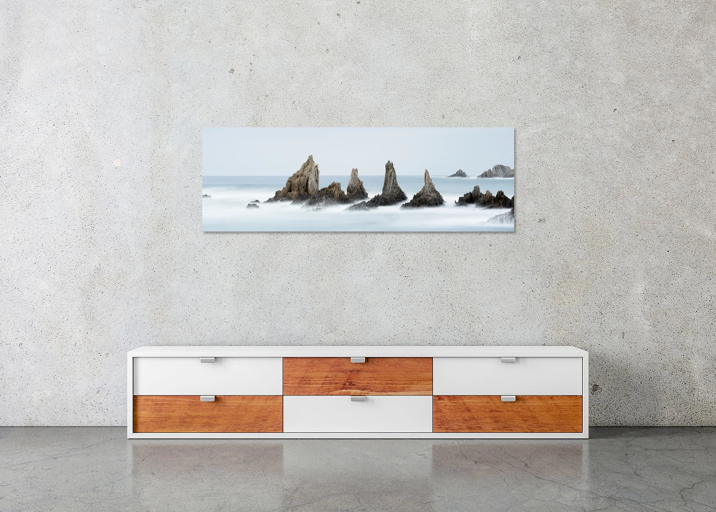 Sea Stack, Study 3 – Bay of Biscay, Spain, frameless colour photograph on aluminium Dibond displayed above a low cabinet.
