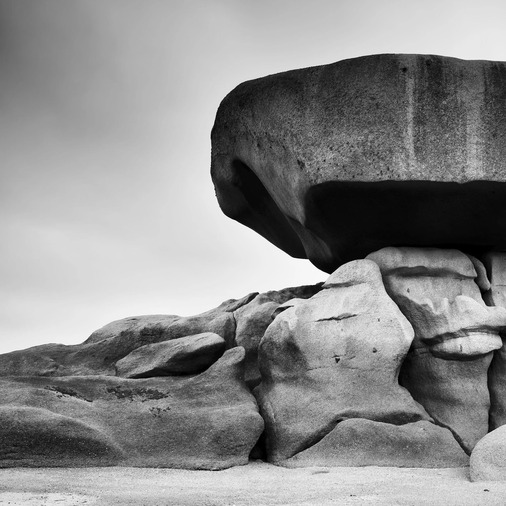 Pink Granite Coast Panorama Study 2 by Gerald Berghammer, black-and-white close-up of weathered granite textures and the left side of a balanced boulder.