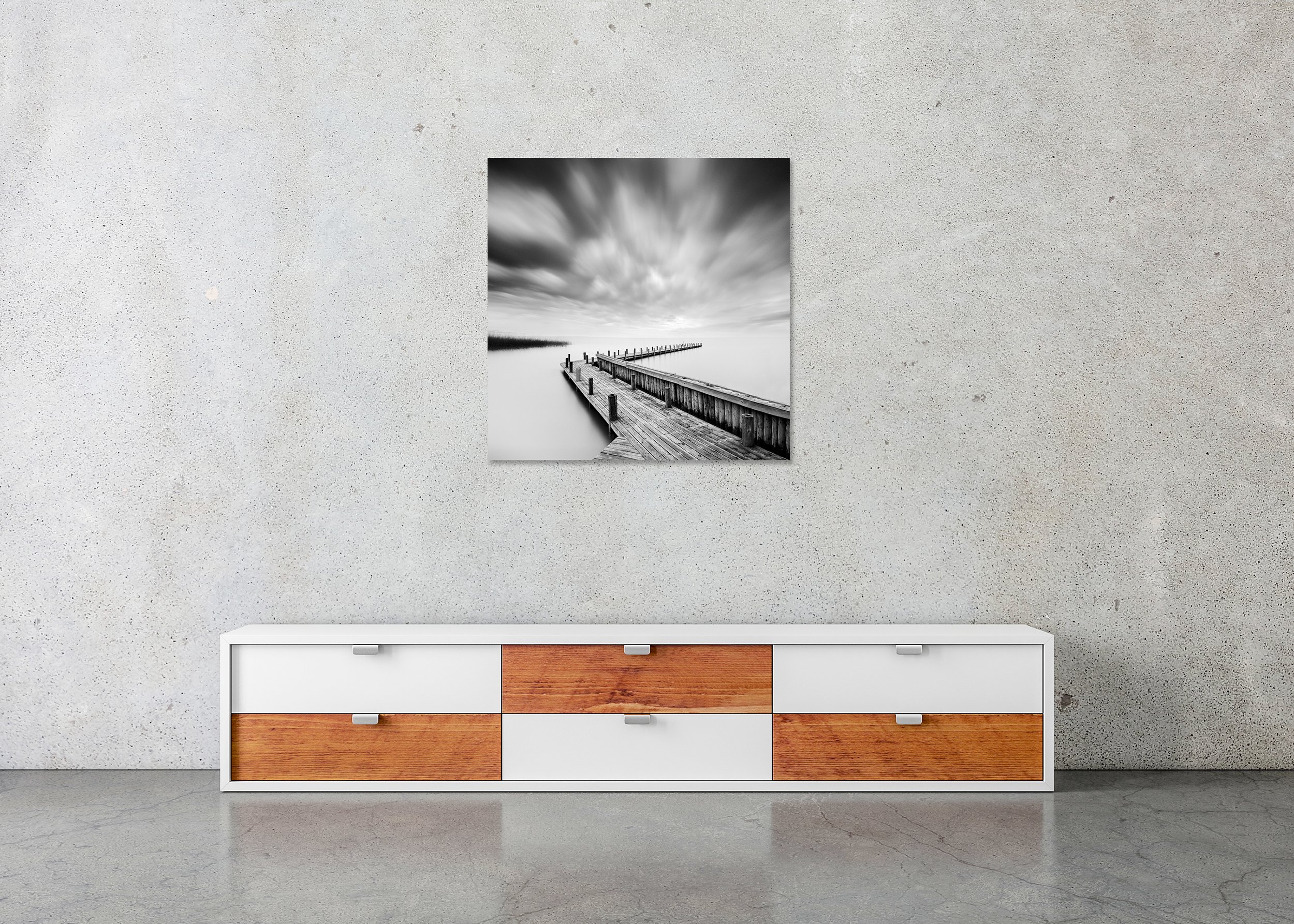 Black and white fine art photo of a wooden pier on a calm lake under dramatic clouds, mounted to Dibond, frameless