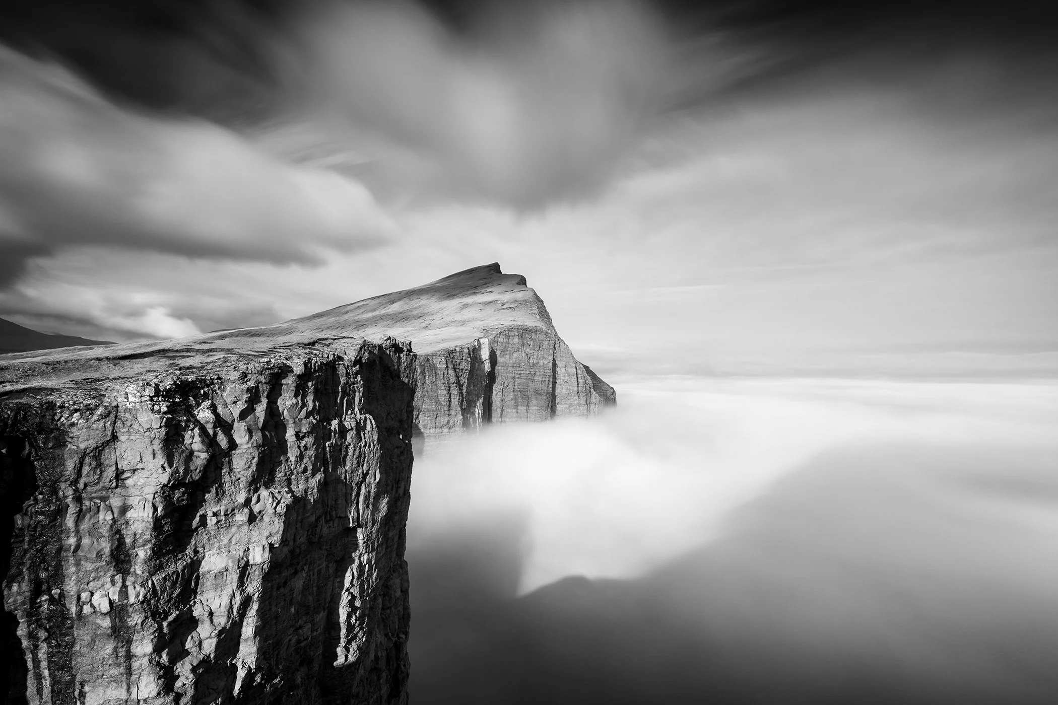 Foggy Slave Cliff, Study 1 – mist-covered Trælanípa in the Faroe Islands, photographed in black and white by Gerald Berghammer.
