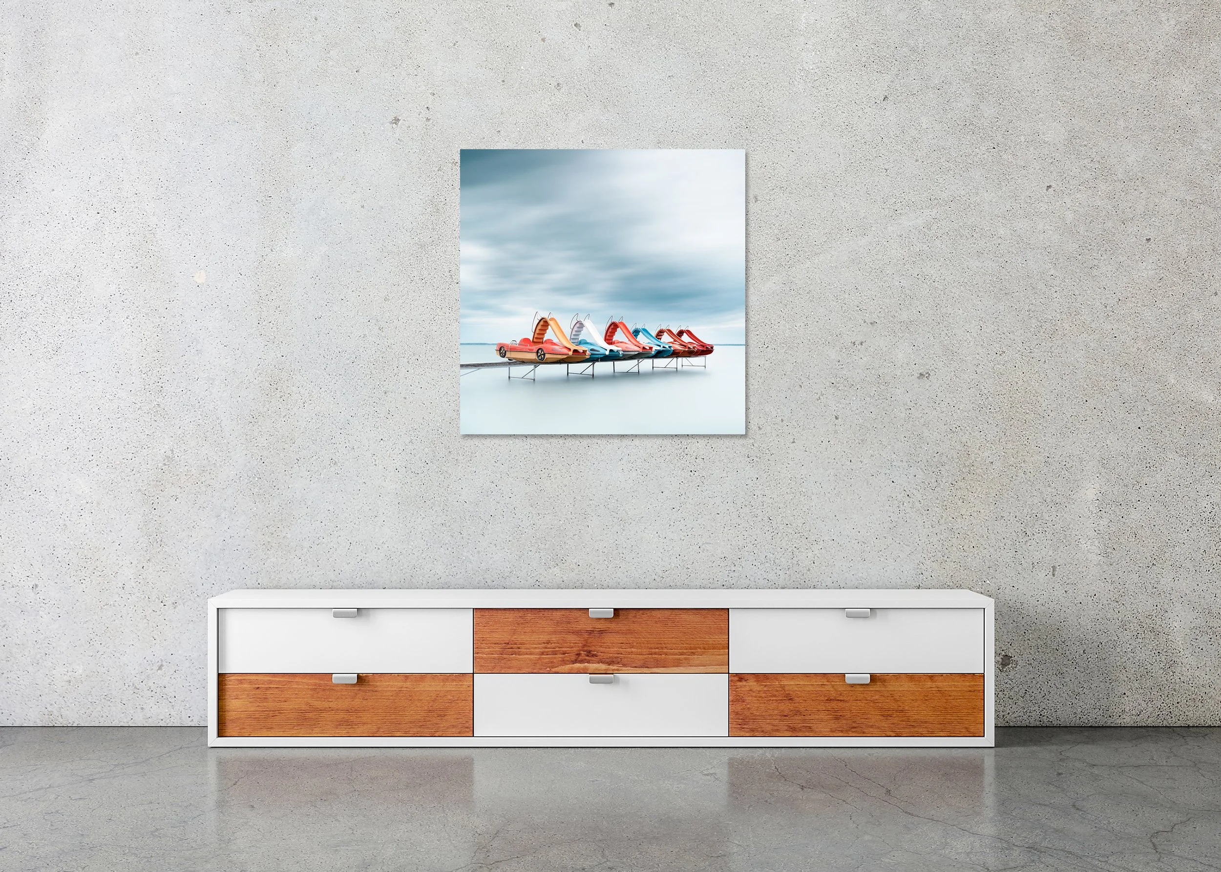 Row of Colourful Pedal Boats – Lake Balaton, frameless colour photograph on aluminium Dibond displayed above a low cabinet.