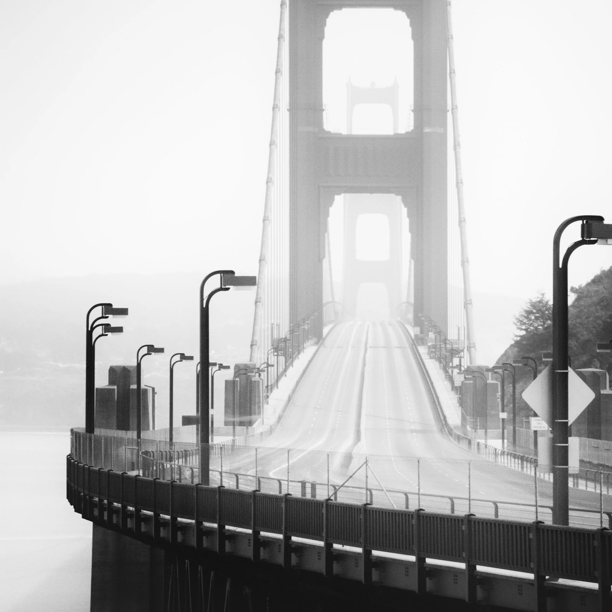 Detail of Golden Gate Bridge Study 7 by Gerald Berghammer showing the empty bridge roadway and repeating streetlights in coastal fog.