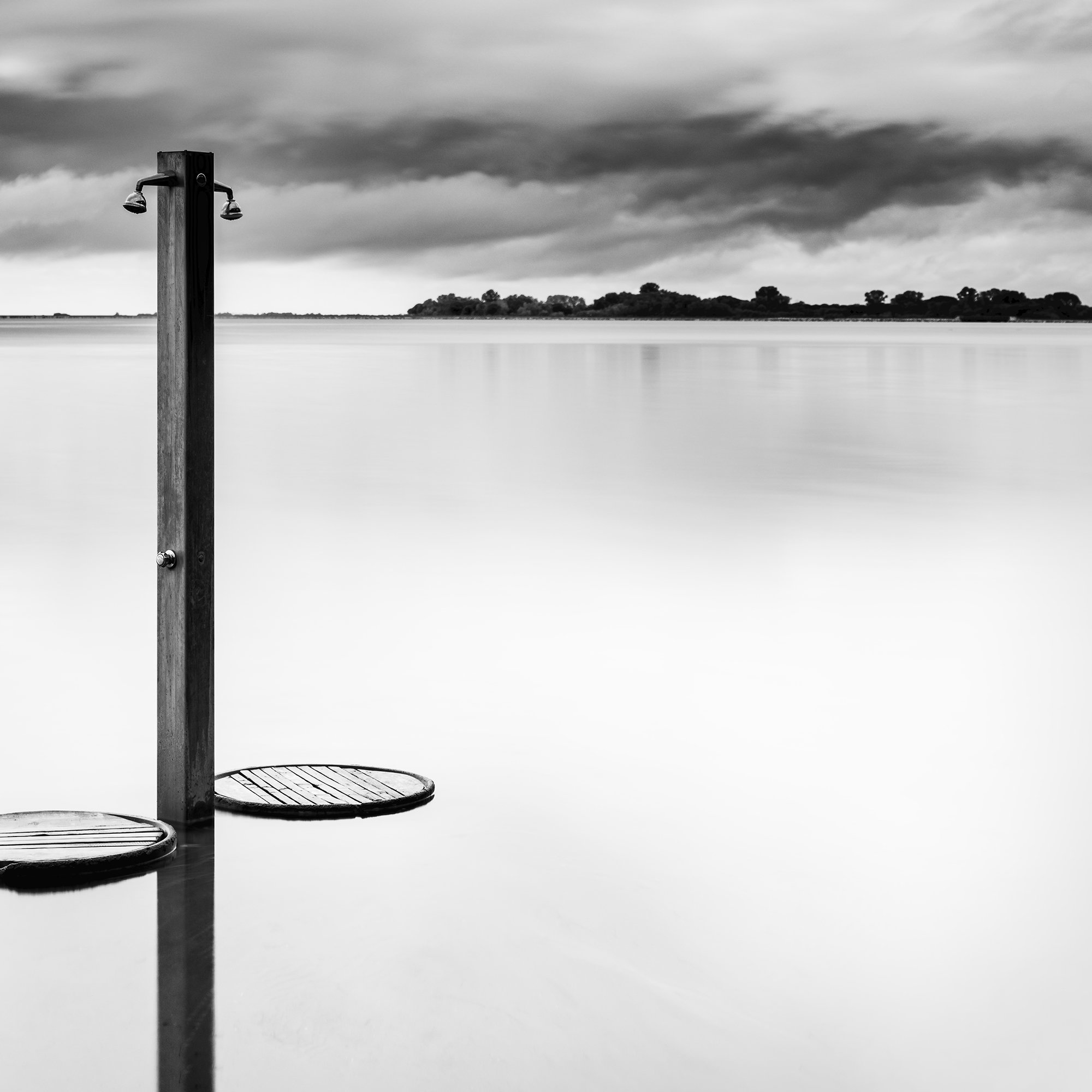 Cropped view of Beach Shower in a Storm – solitary beach shower and stormy Tuscan waterscape by Gerald Berghammer.
