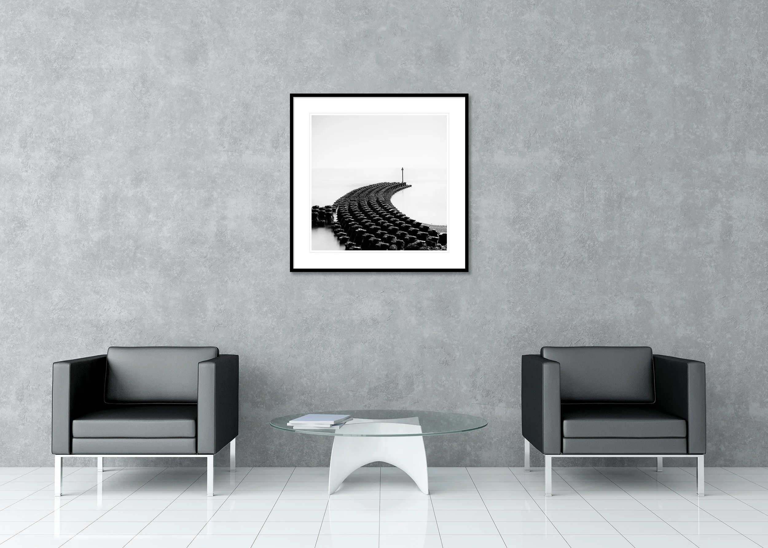 Archival pigment print of black and white coastline with curved groynes in classic frame with mount