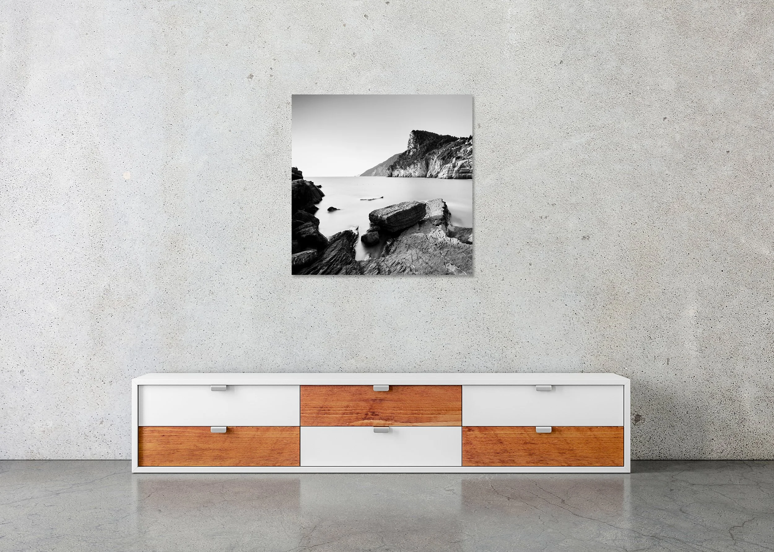 The Rocky Coast of Porto Venere – frameless black-and-white photograph on aluminium Dibond displayed in a minimalist interior.