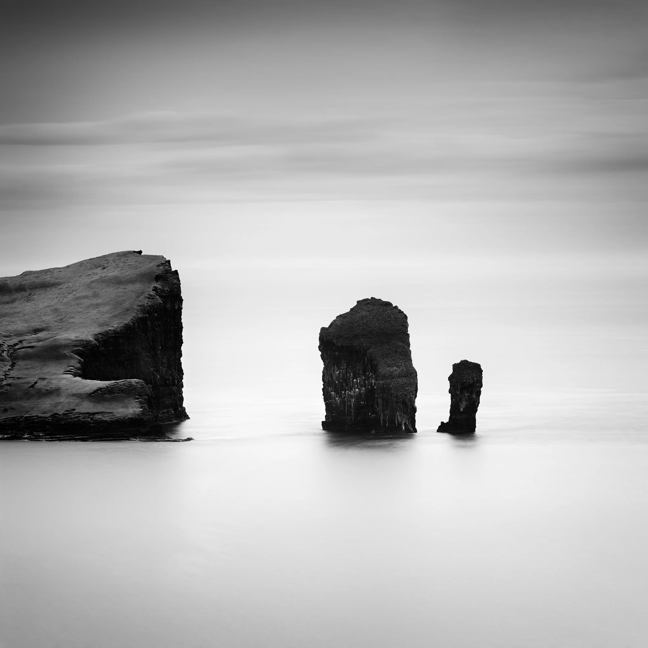 North Atlantic Basalt Study 1 by Gerald Berghammer, minimalist black-and-white long-exposure seascape of basalt sea stacks in the Faroe Islands.