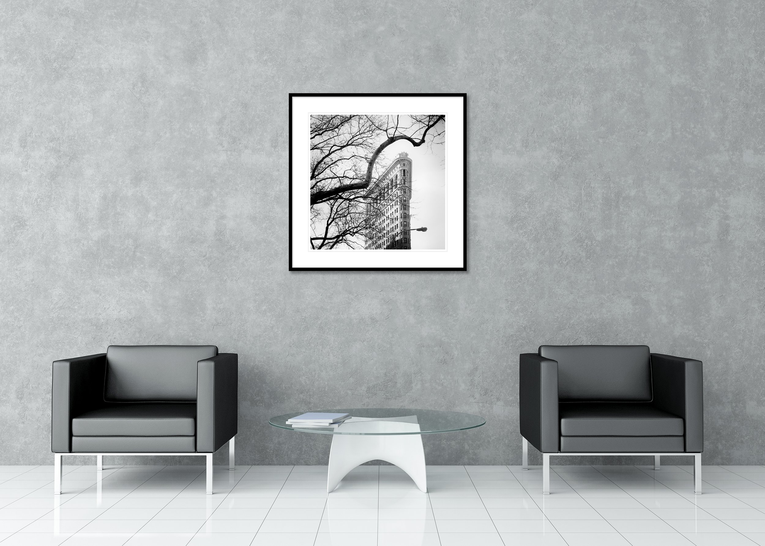 Flatiron Building Study 1 displayed in a modern interior as an archival pigment print in a black aluminium frame with white mount by Gerald Berghammer.