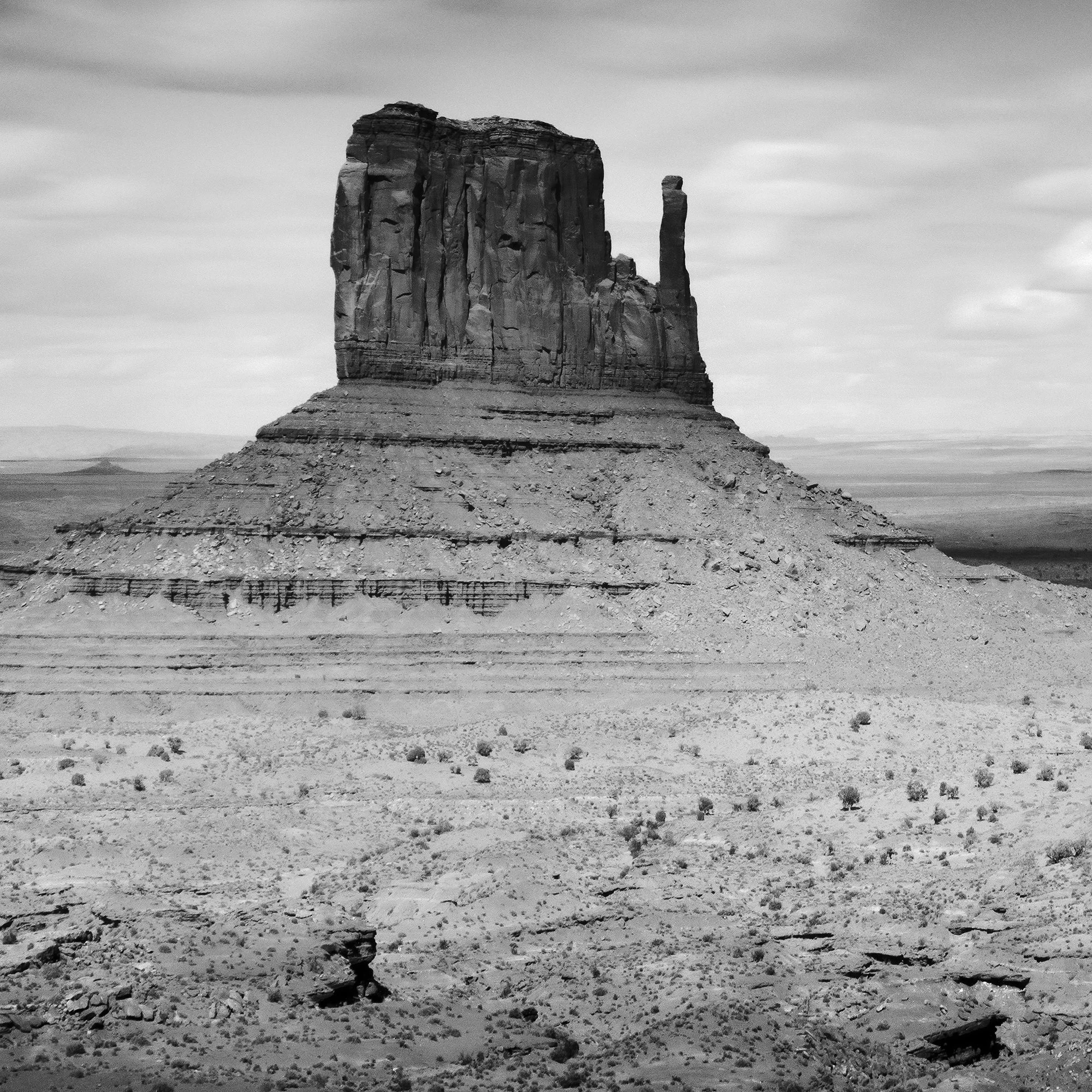 © 2015 Gerald Berghammer - Black and white photo. Large rock formations in a desert landscape, with a winding dirt road in the foreground and a cloudy sky above. Print detail 3