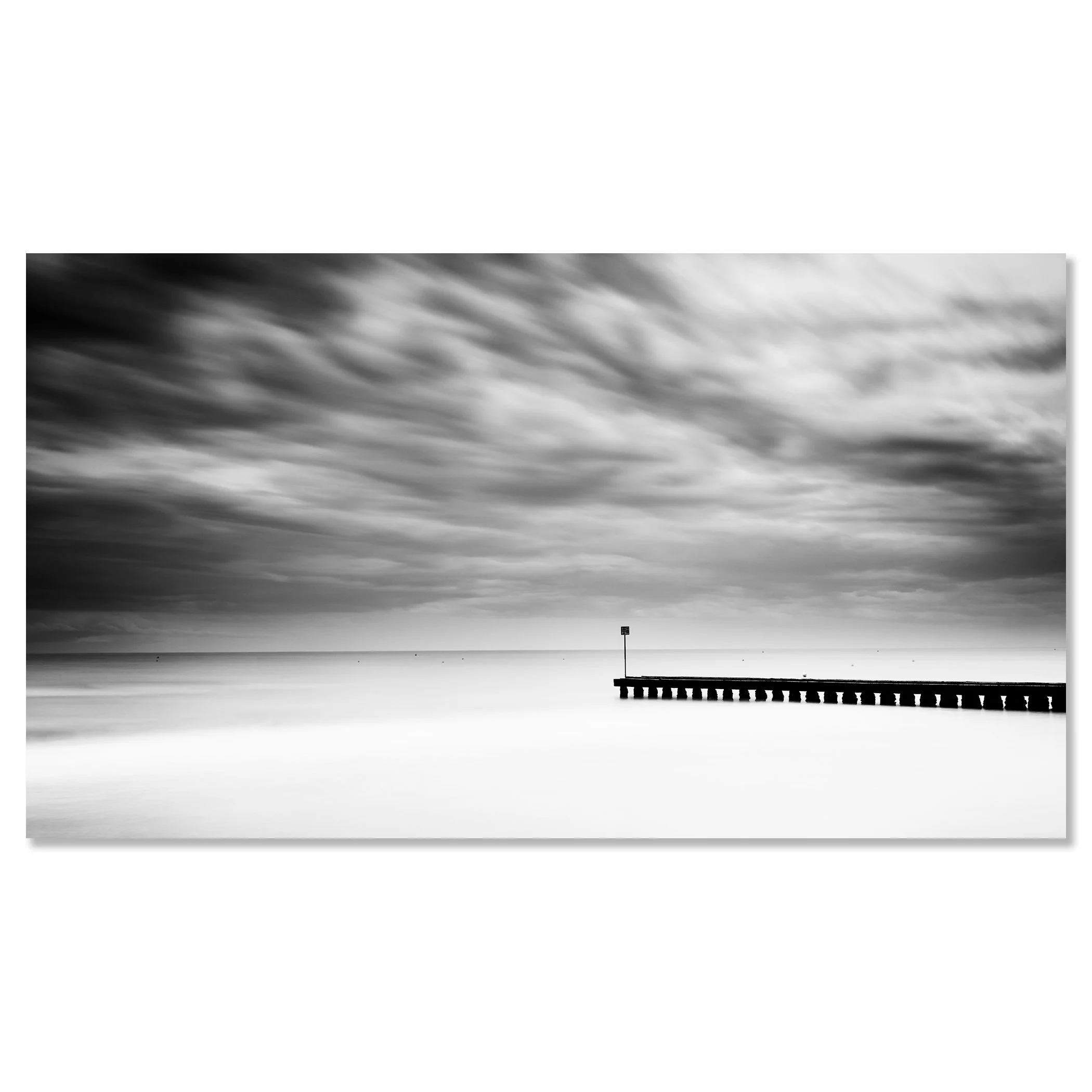 A wooden pier extending into a calm body of water with a cloudy sky and stormy weather – dibond frameless