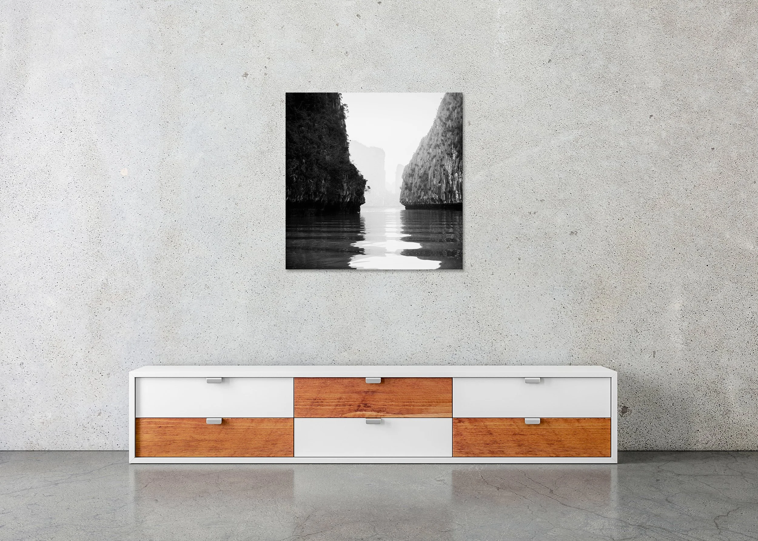 Black-and-white fine art photograph of Ha Long Bay karst limestone cliffs reflected in calm water, photo print mounted to Dibond, frameless.