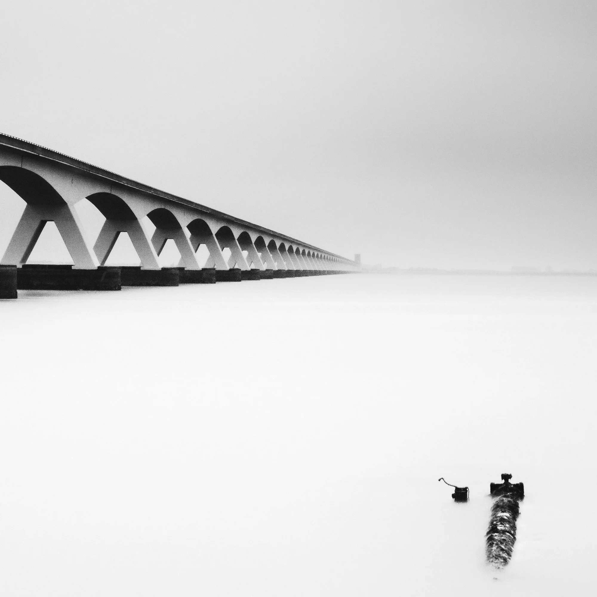 Detail of Zeeland Bridge Study 1 showing the bridge structure and smooth long-exposure water by Gerald Berghammer.