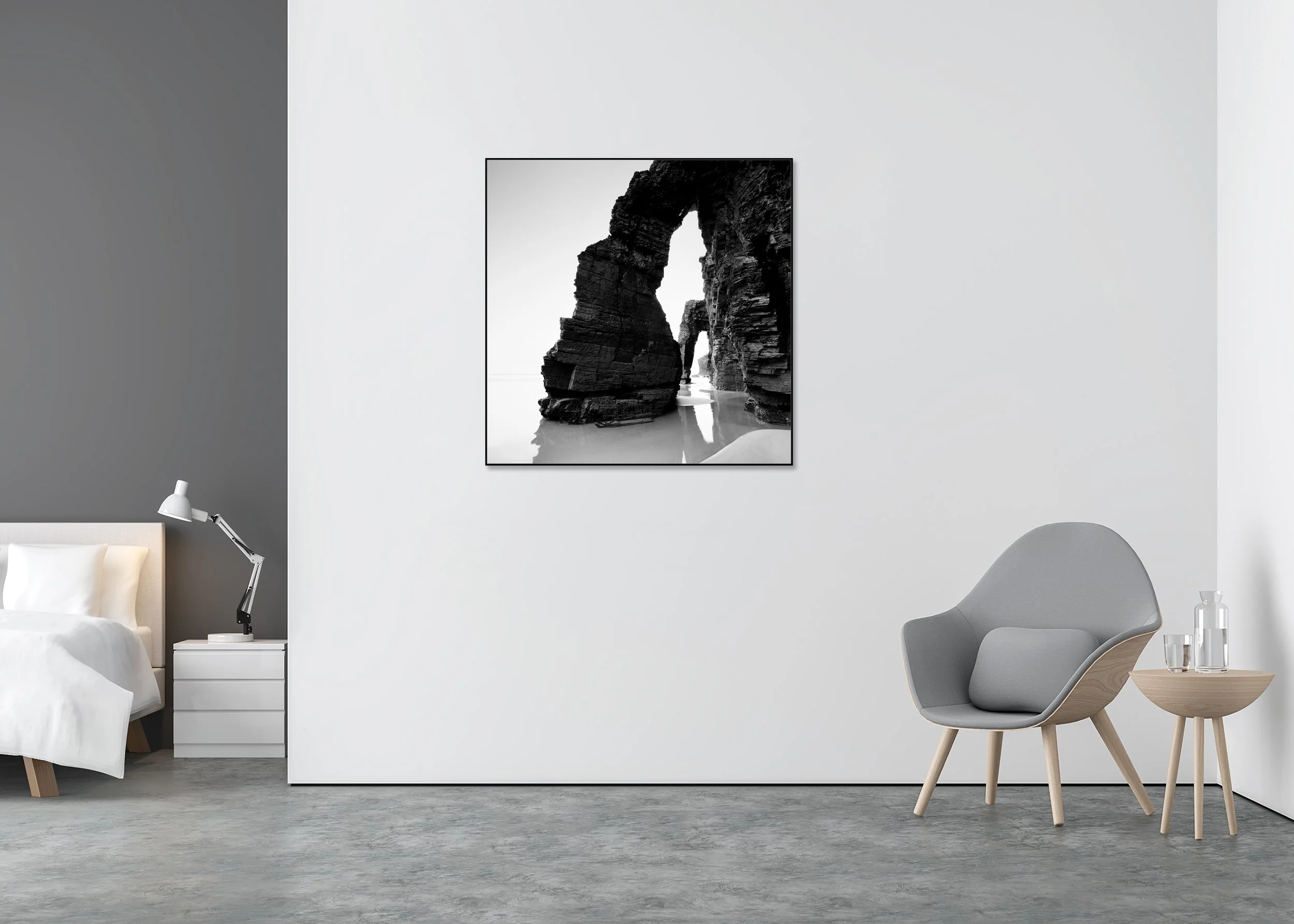 Black and white coastal photo print of rugged cliffs and sea arches reflected in wet sand, mounted to Dibond in an aluminium ArtBox frame