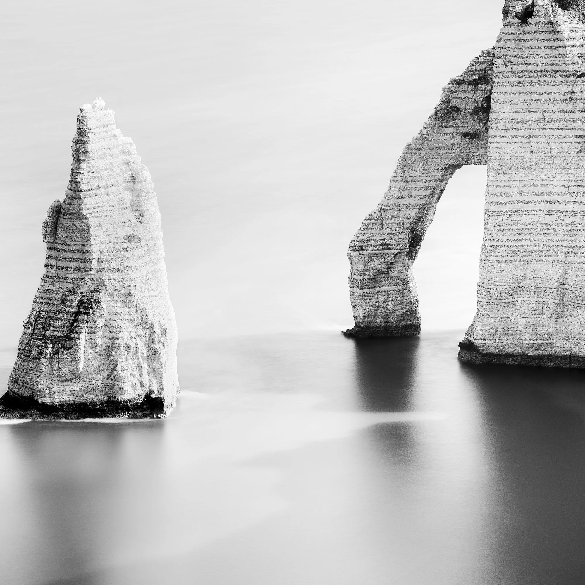 Zoomed-in detail of The Cliffs of Étretat, Study 3, featuring the sea arch, Aiguille and mist-like water. Photo by Gerald Berghammer.