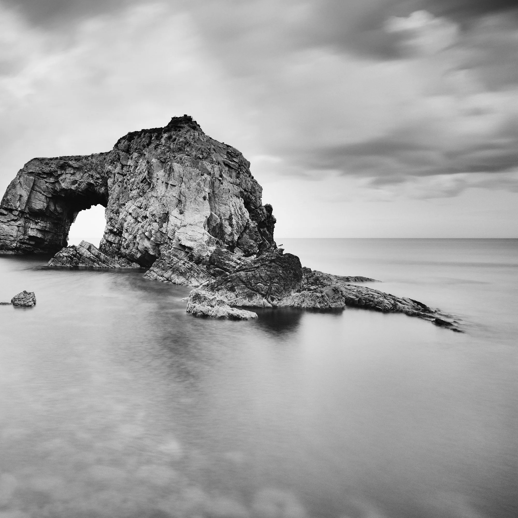 Detail of Great Pollet Sea Arch Study 3 showing the sculptural rock formation and calm Atlantic water in Ireland by Gerald Berghammer.