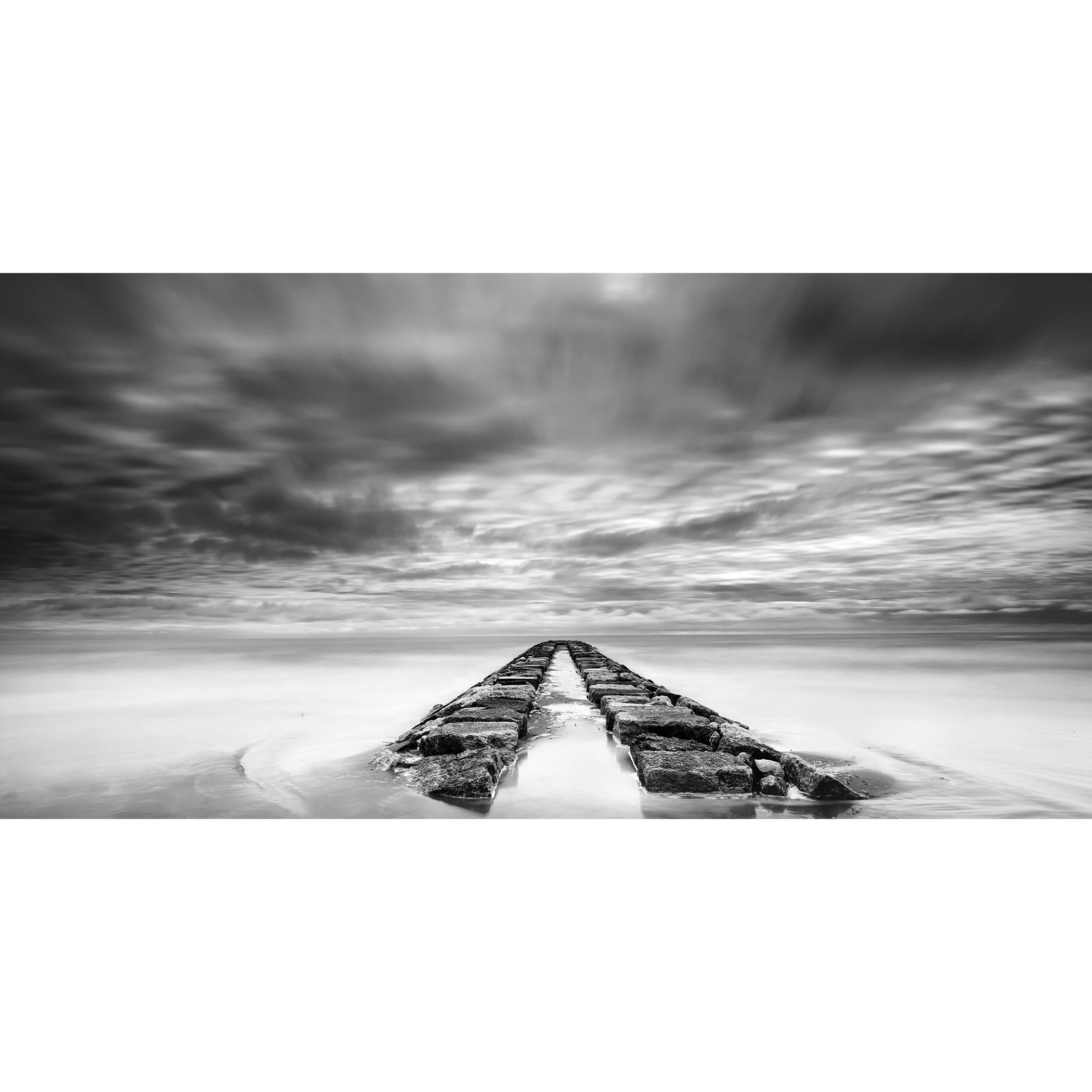 Rock Pier, Panorama Study 1 by Gerald Berghammer, black-and-white long-exposure seascape of a stone breakwater beneath dramatic clouds in Italy.