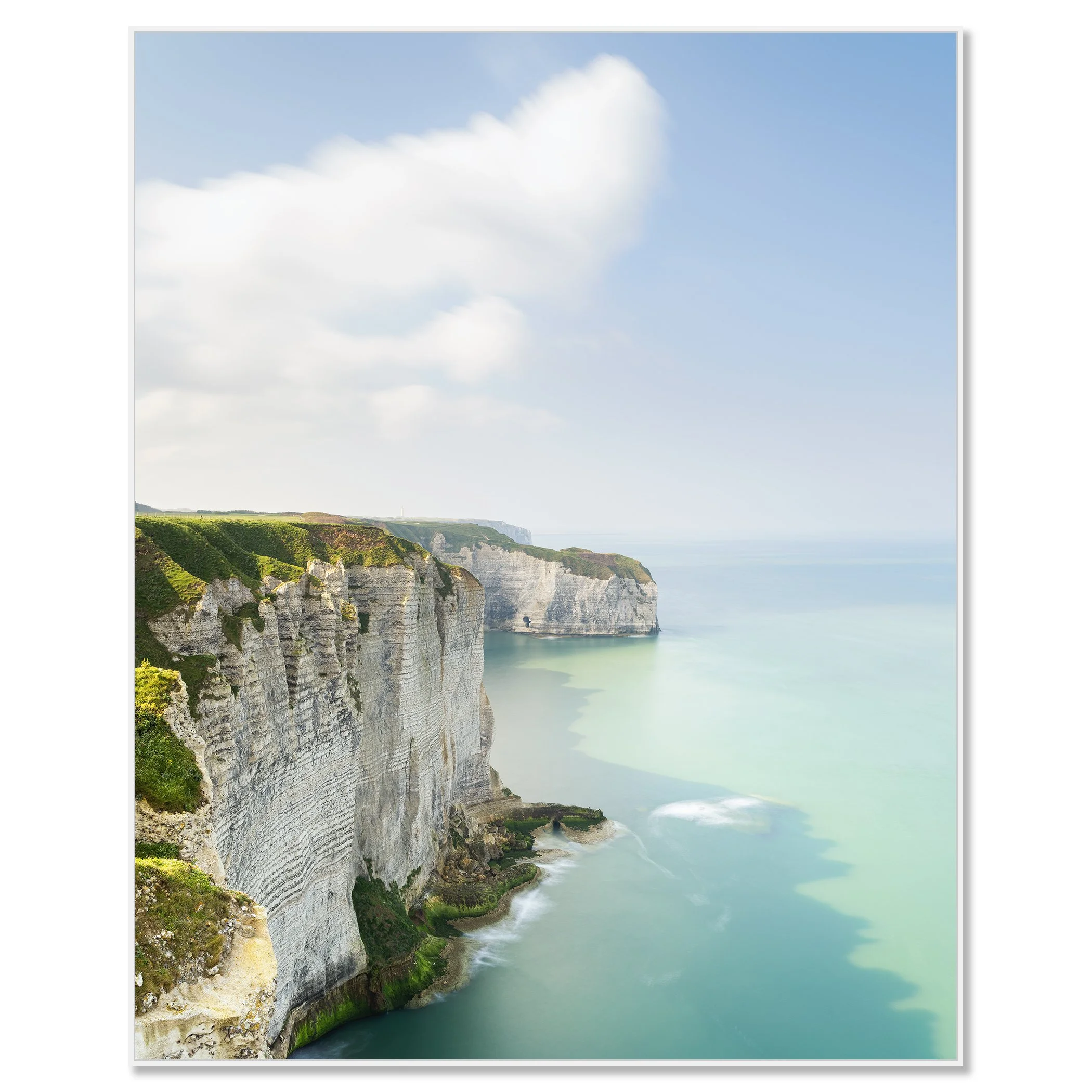 Gerald Berghammer - Color Photography. Cliffs along a coastline with green vegetation, white rock formations, and a calm sea under a partly cloudy sky. Chromaluxe framed white