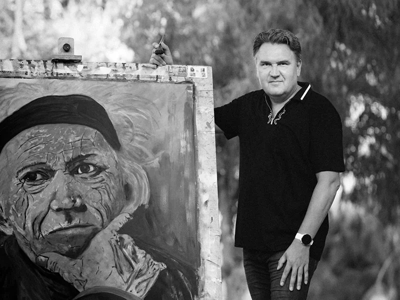 Austrian artist Christian Dressler beside his large-scale portrait painting of Keith Richards.