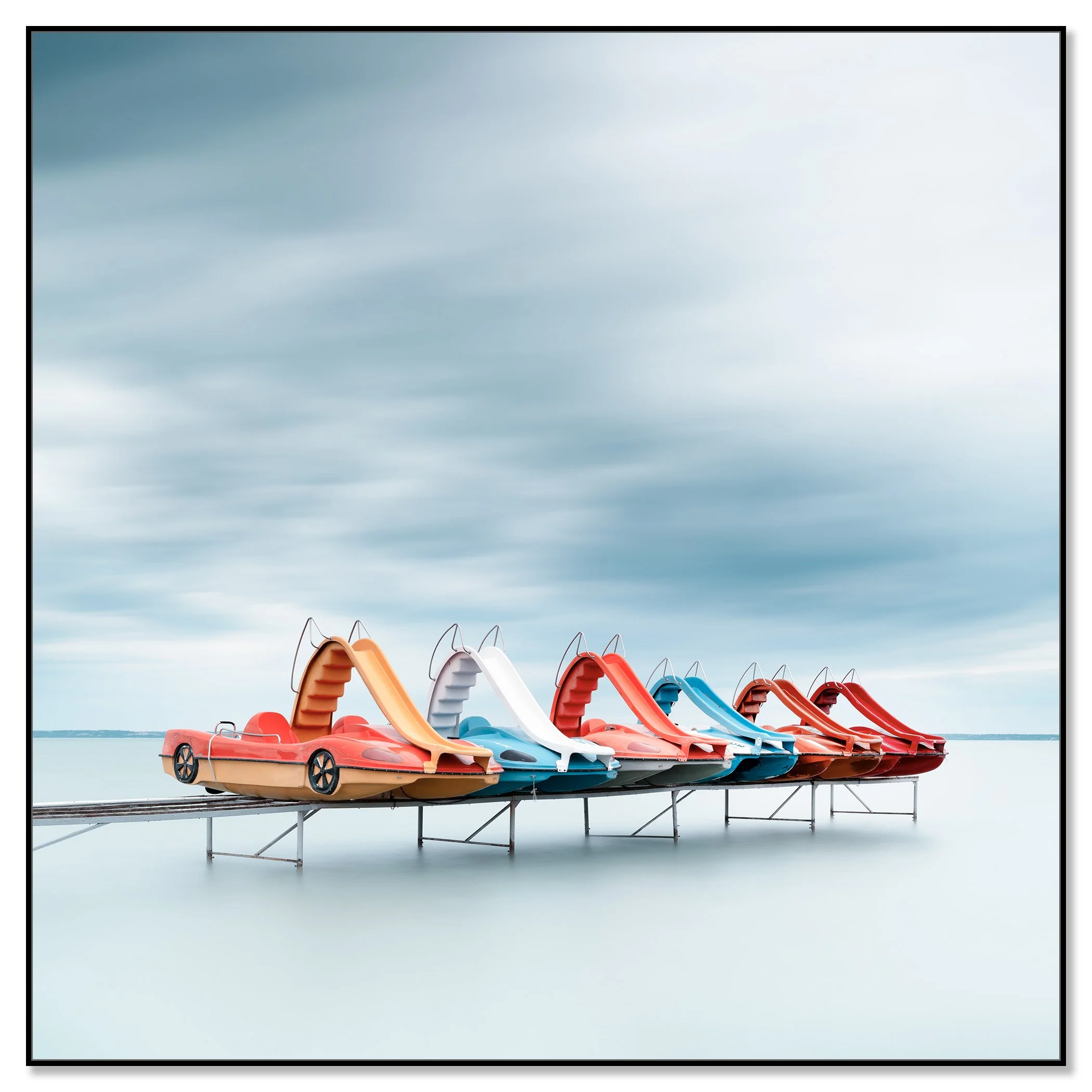 Row of Colourful Pedal Boats – Lake Balaton, colour photograph in a black aluminium ArtBox frame.