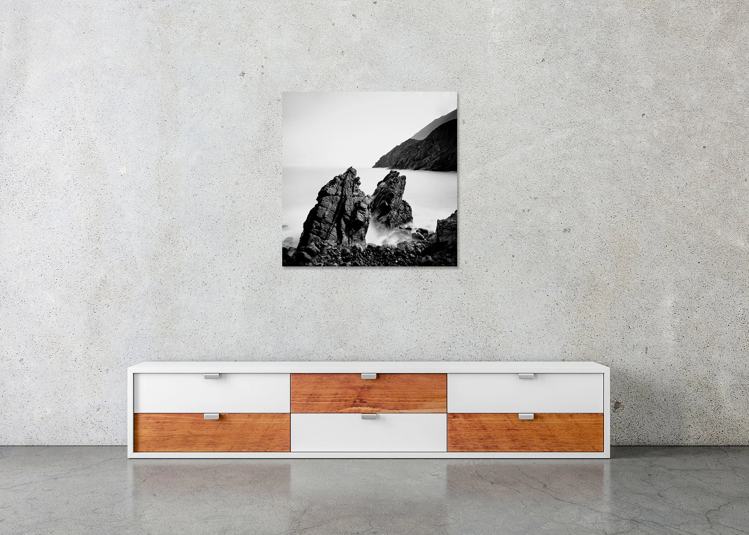 Black and white seascape print of rugged Atlantic rocks and distant mountains beneath a bright sky, photo print mounted to Dibond, frameless.