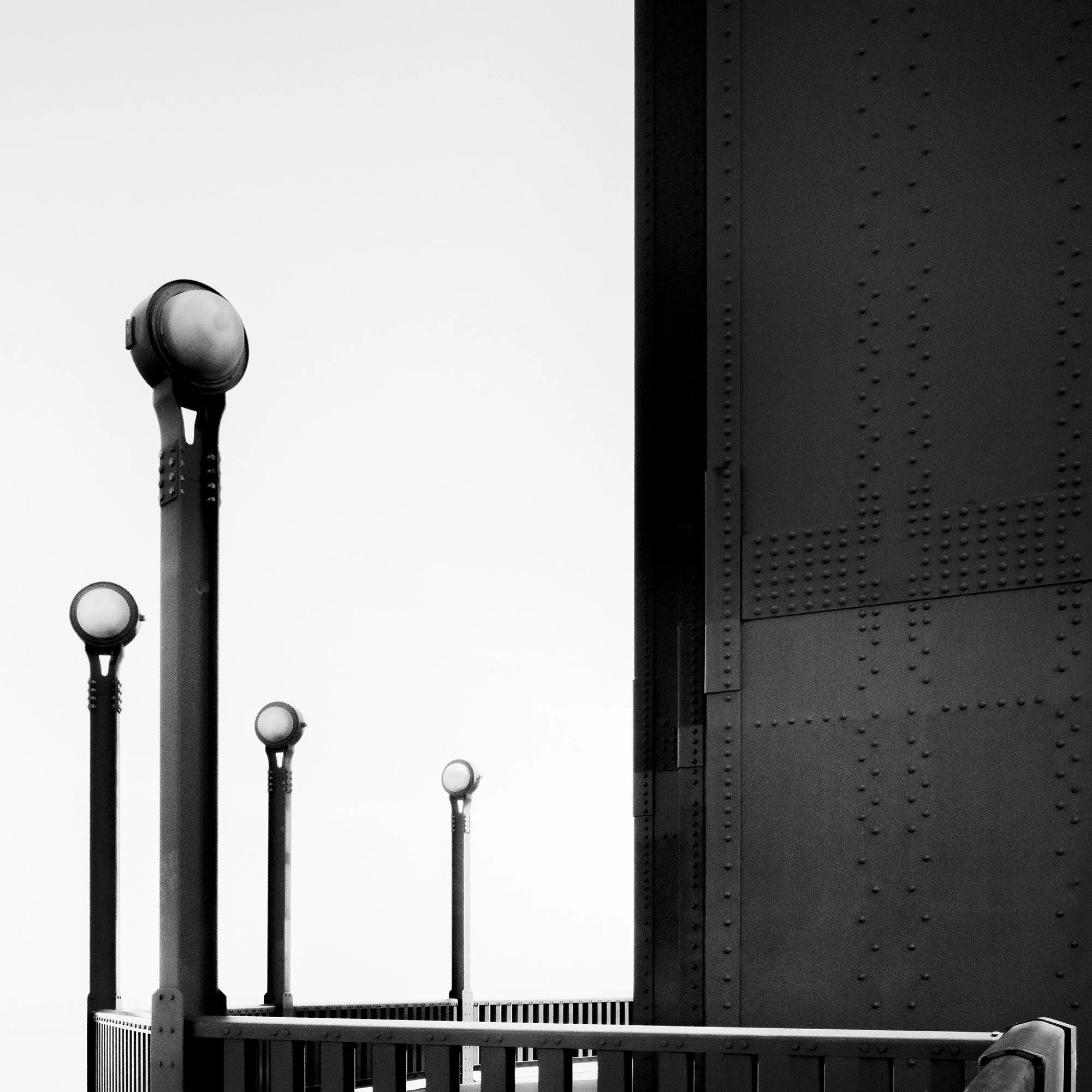 Detail of Golden Gate Study 9 showing lamps, riveted steel and railings of the Golden Gate Bridge in black and white by Gerald Berghammer.