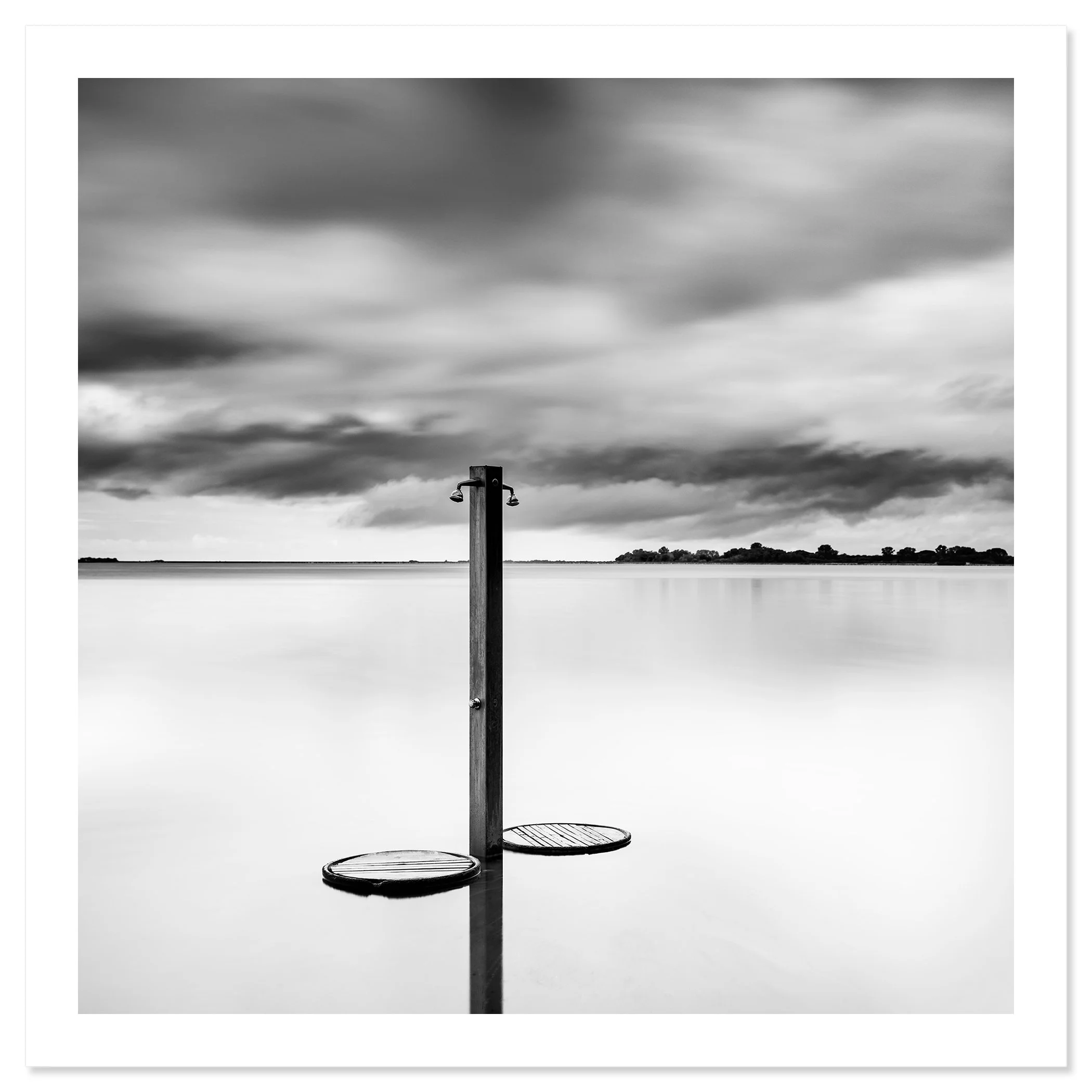 Beach Shower in a Storm – black-and-white fine art print of a solitary beach shower beneath dramatic storm clouds in Tuscany, Italy, by Gerald Berghammer.