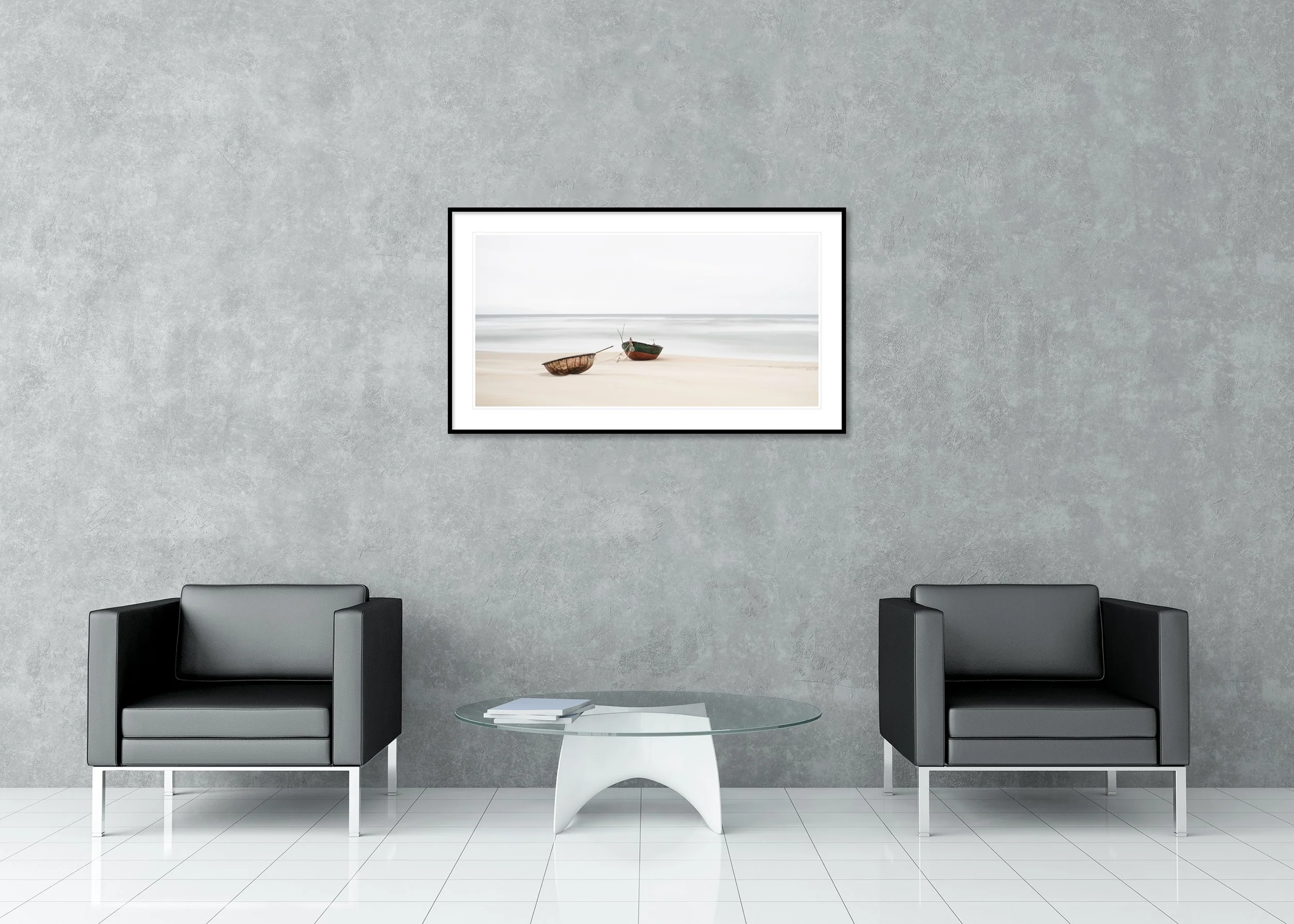 Two old boats on an empty shoreline with calm water and a bright grey sky, archival pigment print in a classic frame with a mount.