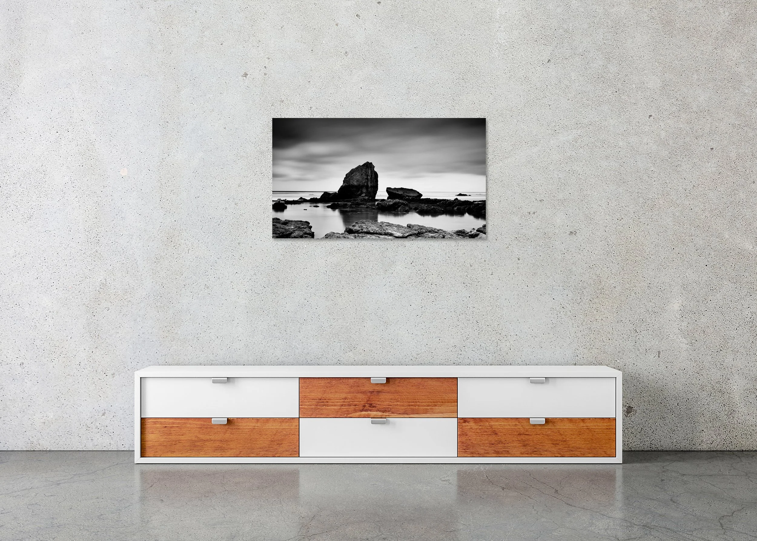 Monochrome coastal landscape print with dramatic sea stack, rocky shoreline and still water at low tide, photo print mounted to Dibond, frameless