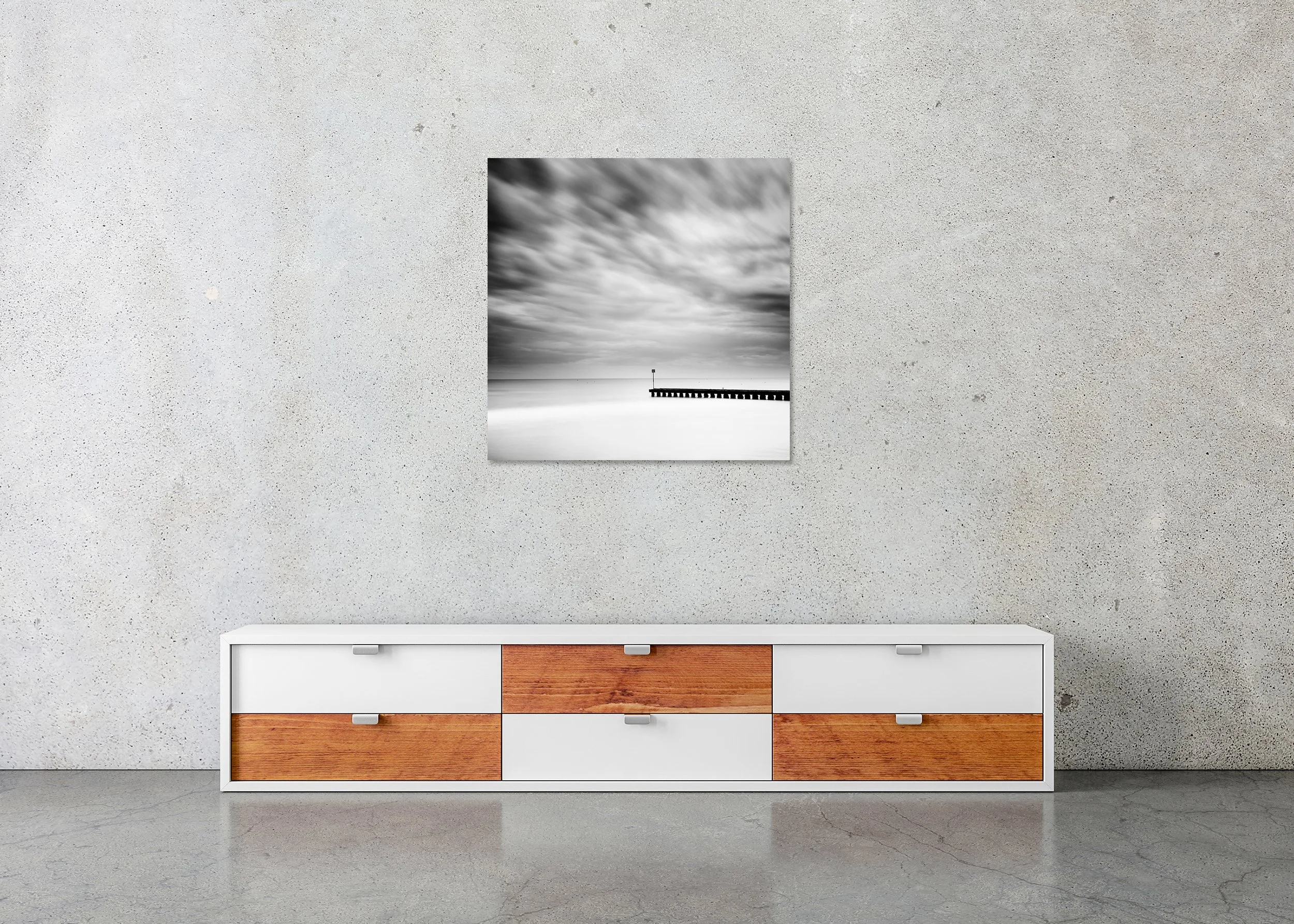 Minimalist black and white beach photo print with blurred clouds and a wooden pier, mounted to Dibond with a frameless finish.