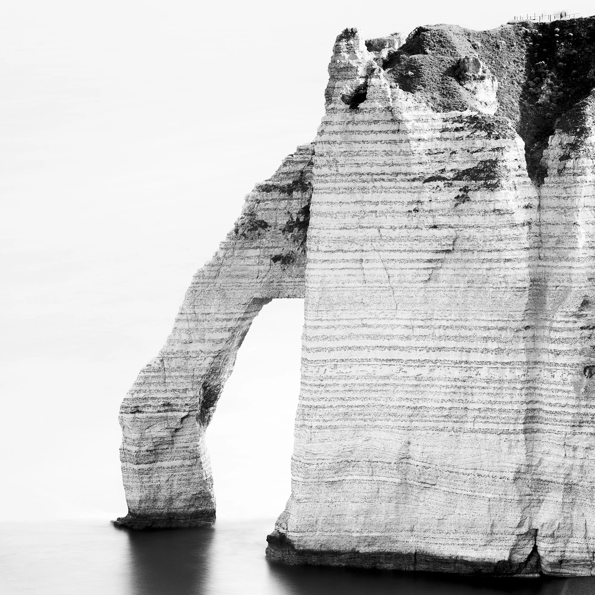 Detail of The Sea Arch at Étretat, France, black-and-white seascape texture. Photo by Gerald Berghammer.