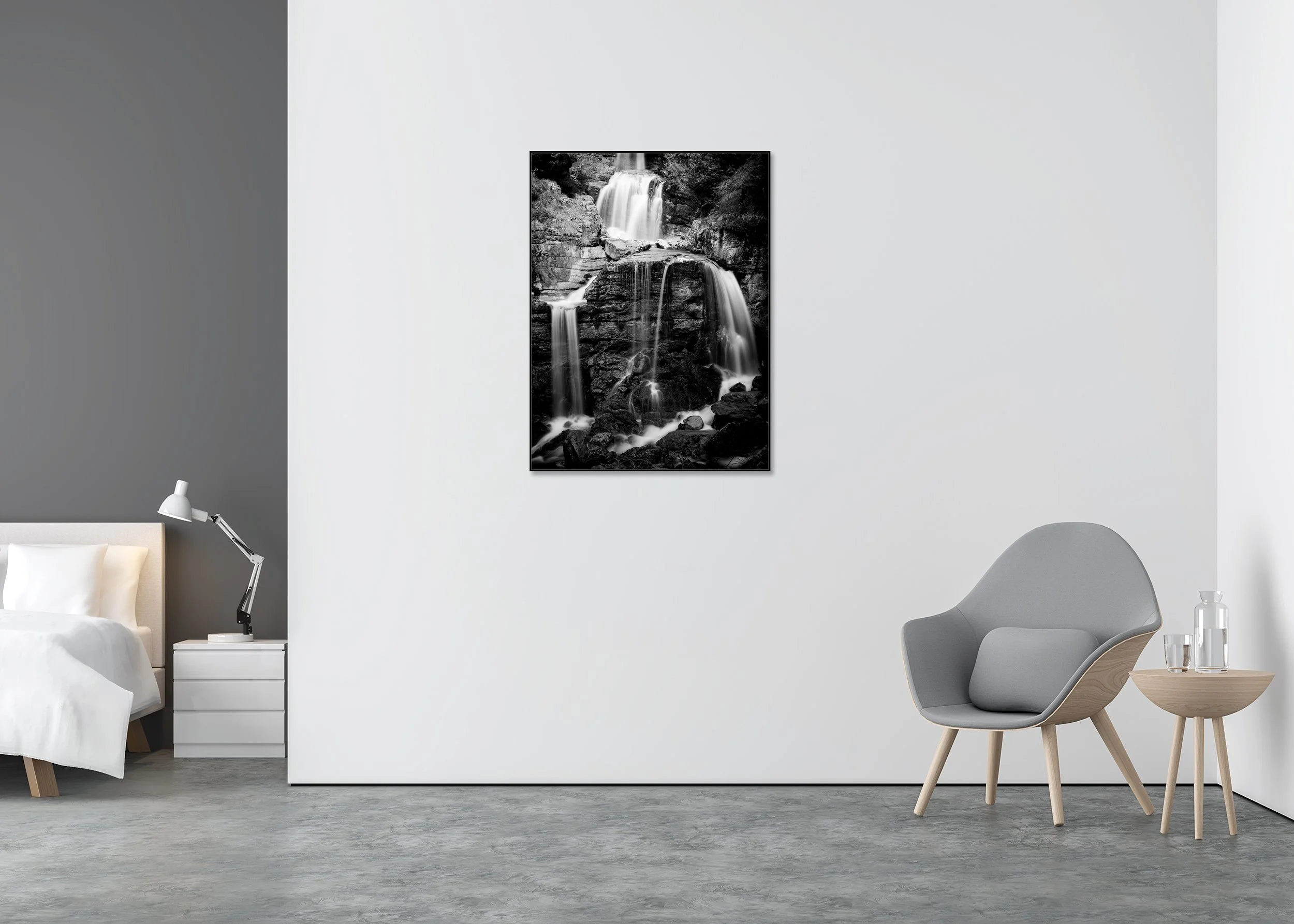 Lower Kuhflucht Waterfall – black-and-white Dibond print in a black aluminium ArtBox displayed in a minimalist bedroom.