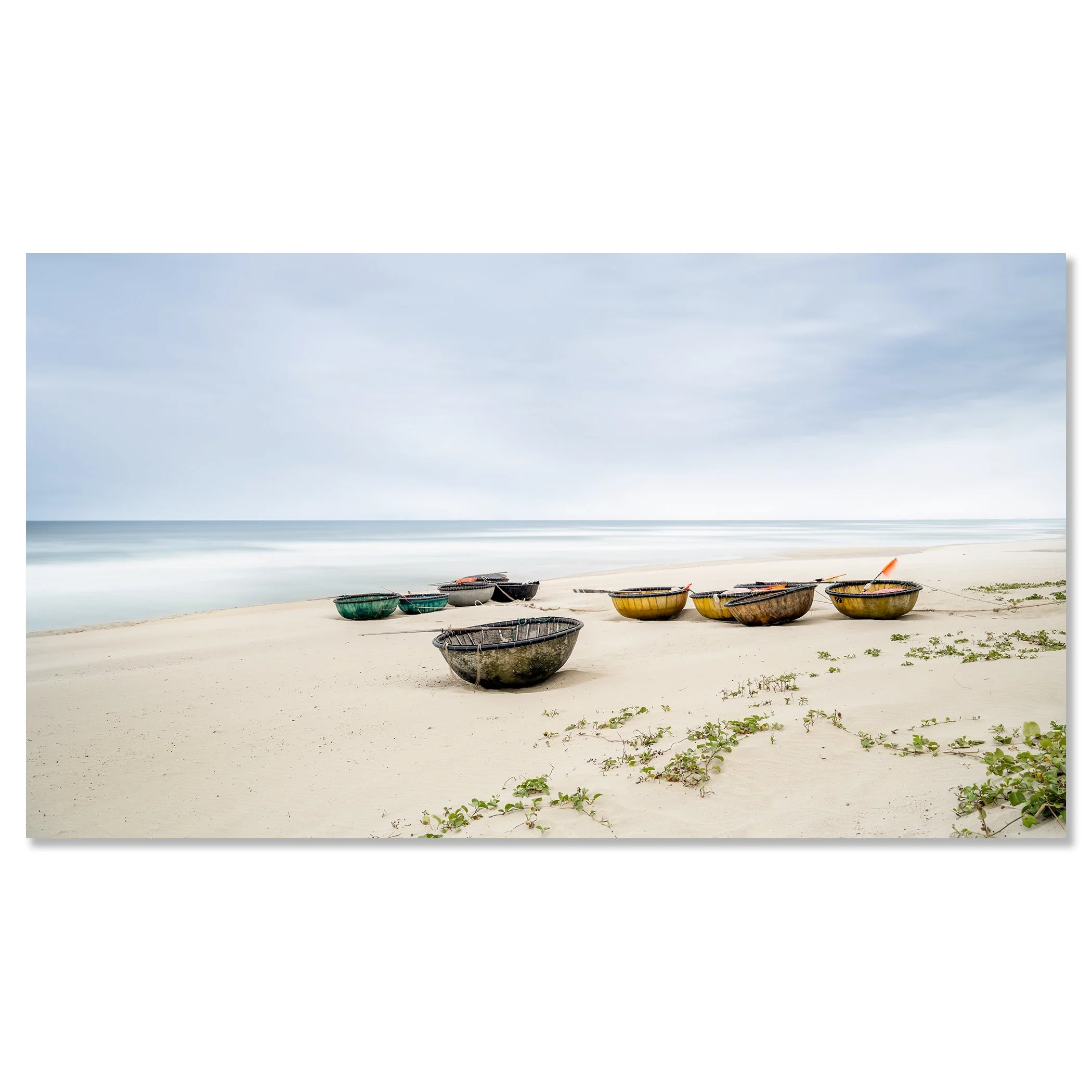 Colorful coconut boats on sandy beach in Vietnam, calm sea, sparse green vegetation under cloudy sky – dibond frameless