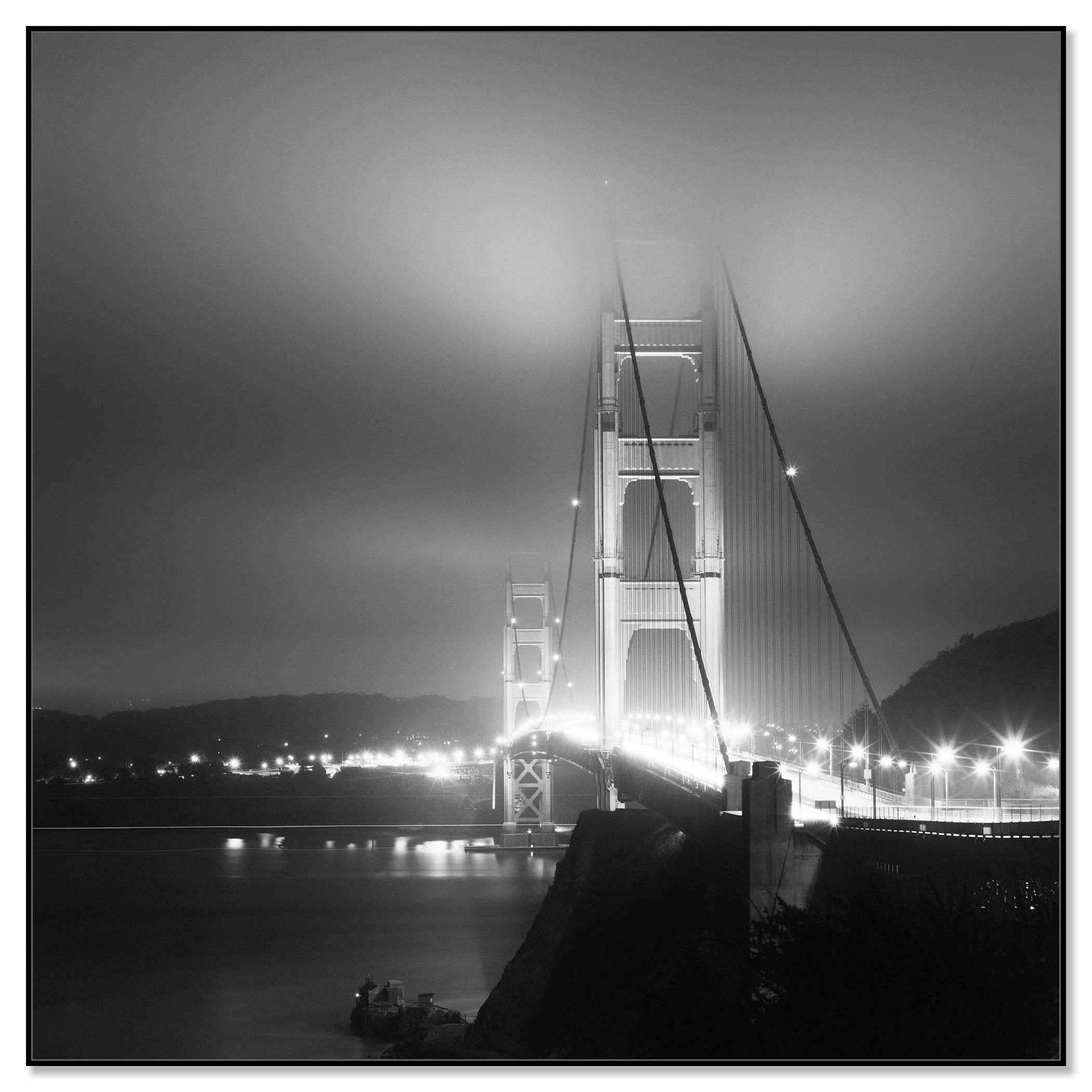Moody black and white view of the Golden Gate Bridge illuminated at night in San Francisco – framed ArtBox black