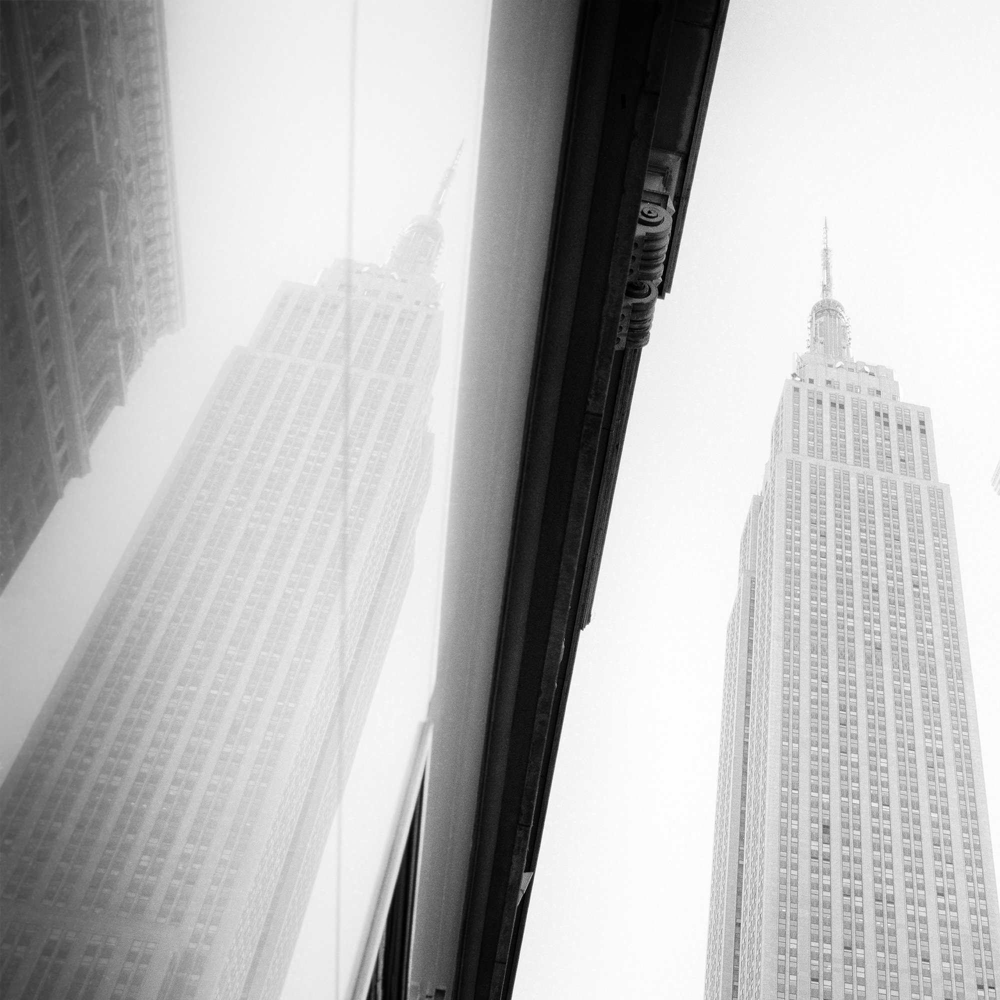Detail of Empire State Building Study 1 by Gerald Berghammer showing the skyscraper and its reflection in New York City.