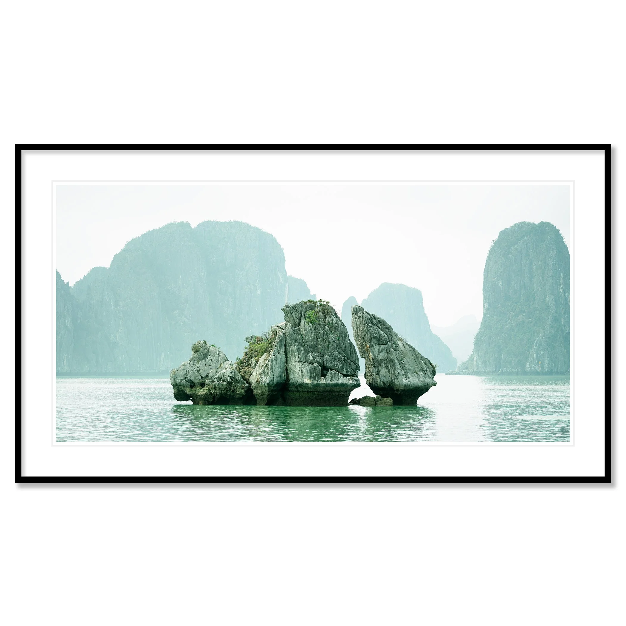 Gerald Berghammer - Color seascape photography. Large rocks rising from the water with, surrounded by calm water and distant limestone cliffs and islands. Classic framed black