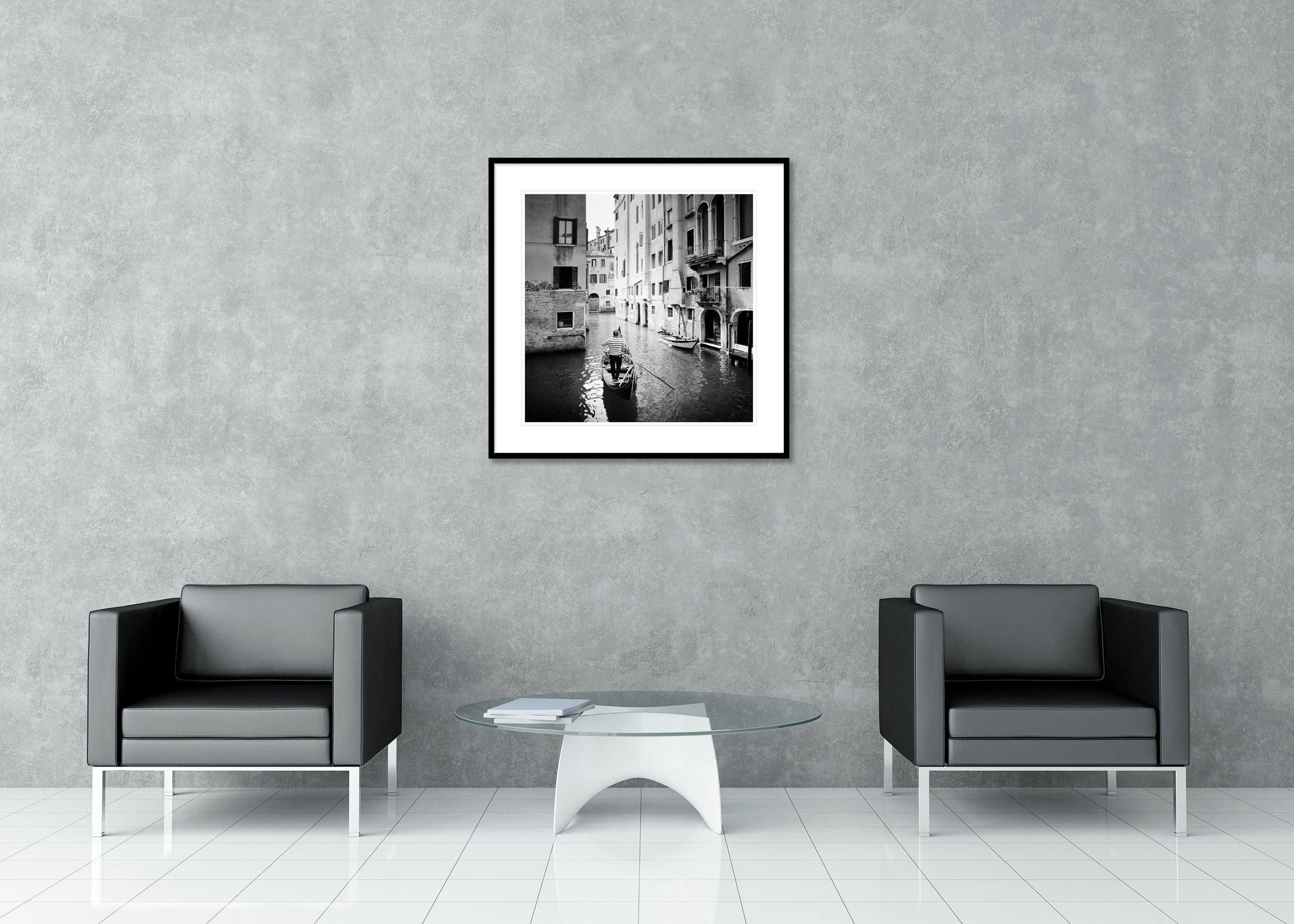 Archival pigment print classic frame with passe-partout featuring a black-and-white photograph of a gondolier navigating a narrow canal in Venice, Italy, between historic buildings.