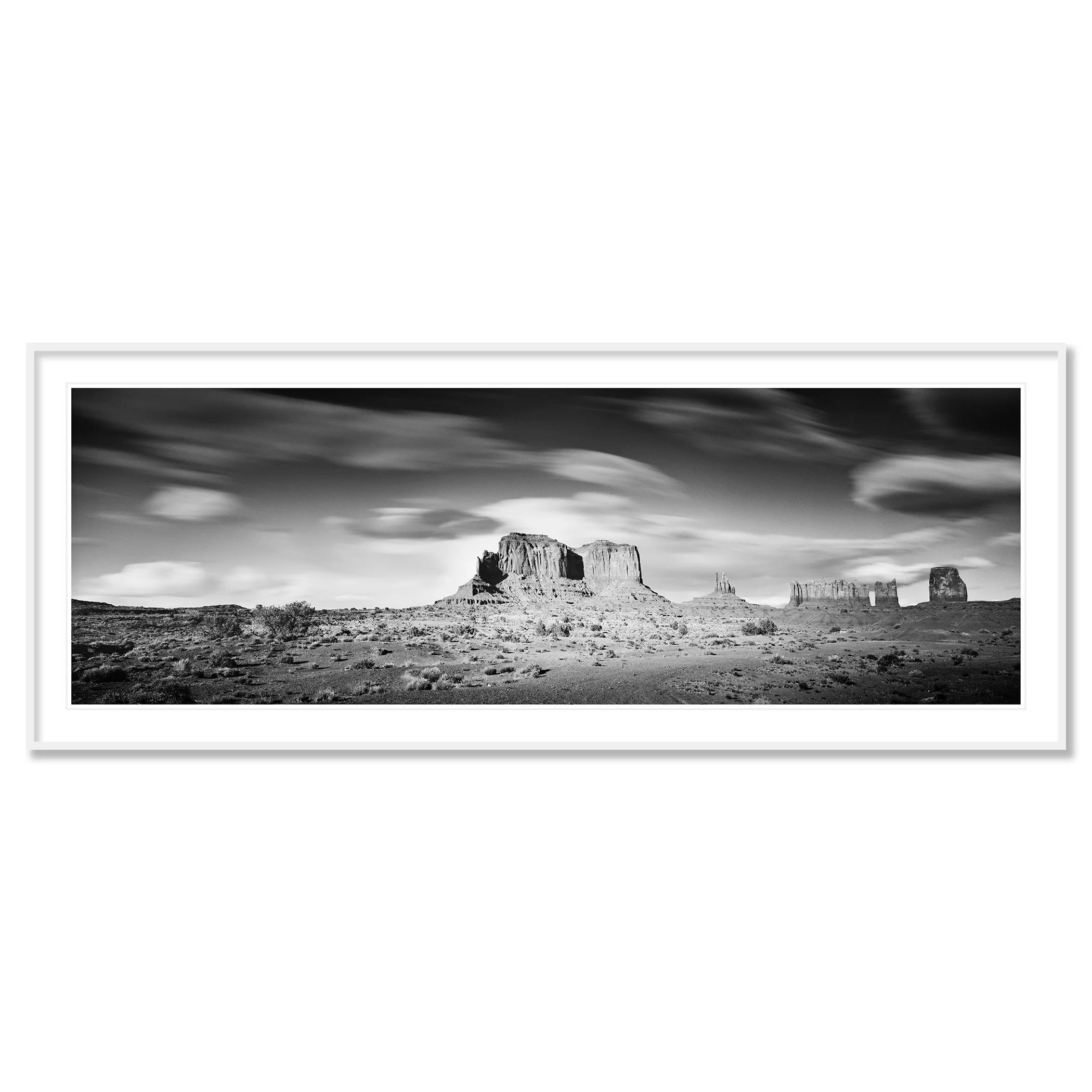 © 2015 Gerald Berghammer - Black and white photography. Landscape of rugged desert terrain with large rock formations and scattered vegetation under a cloudy sky. Classic framed white