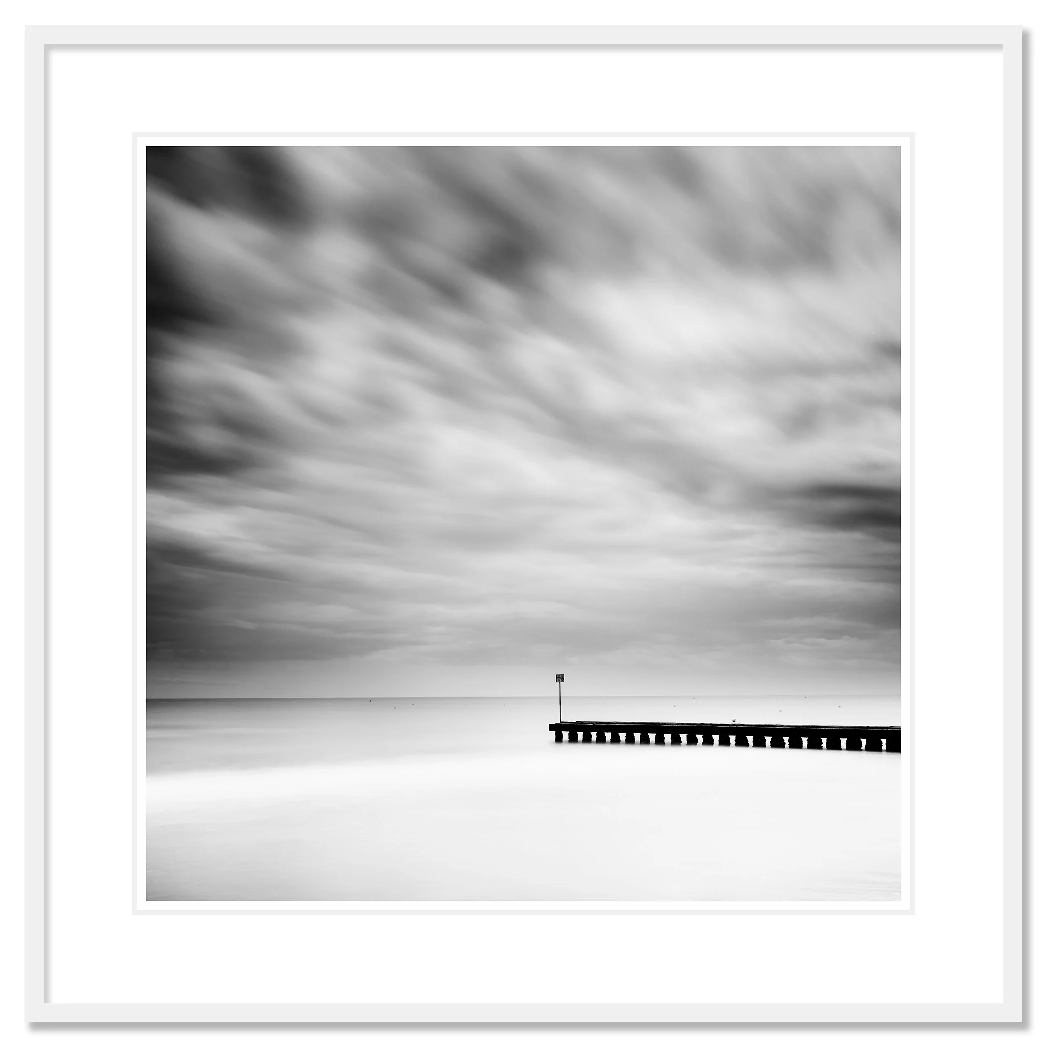 Wooden Pier in the Sea Study 1 – black-and-white fine art photograph from Italy in a white aluminium frame with a white mount by Gerald Berghammer.
