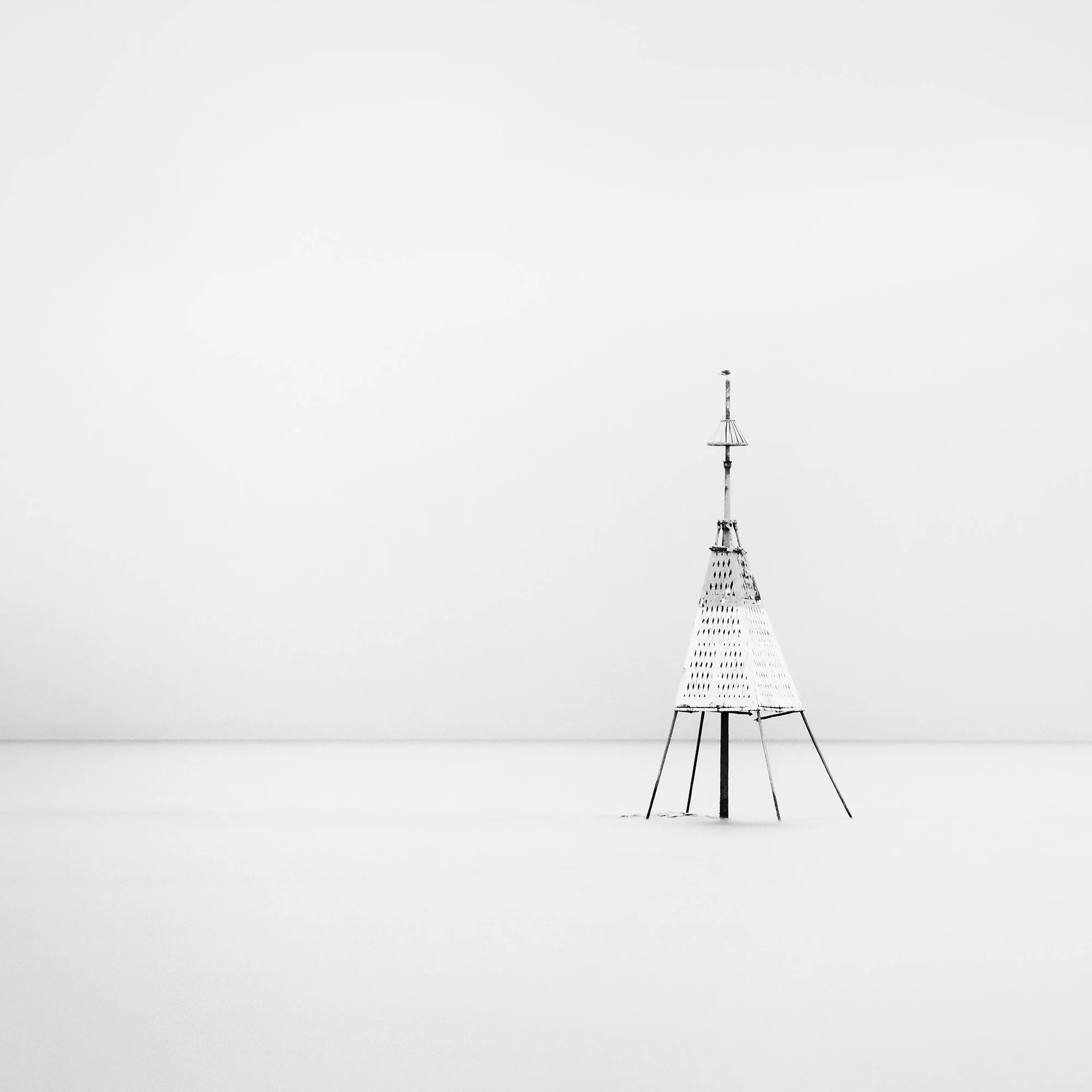 Gerald Berghammer - Black and white long exposure seascape photography. Solitary metal structure lighthouse with a conical top, standing in the Ocean. Print detail 1